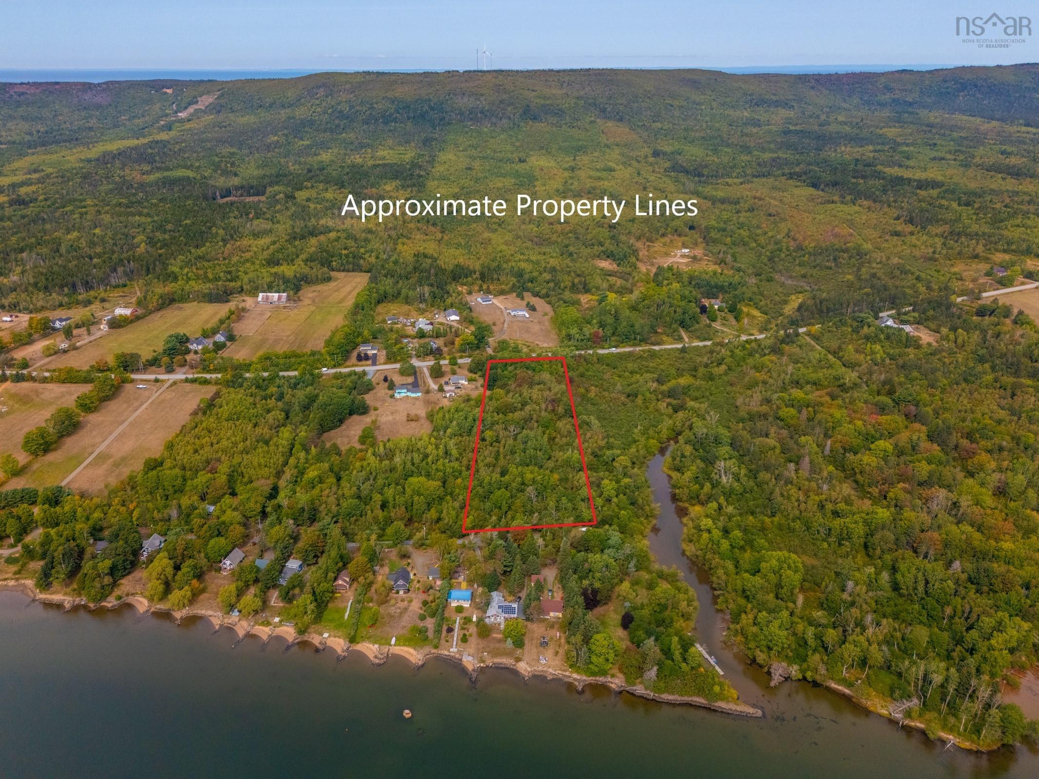 Aerial overview of property's location with property parcel outlined and a nearby body of water