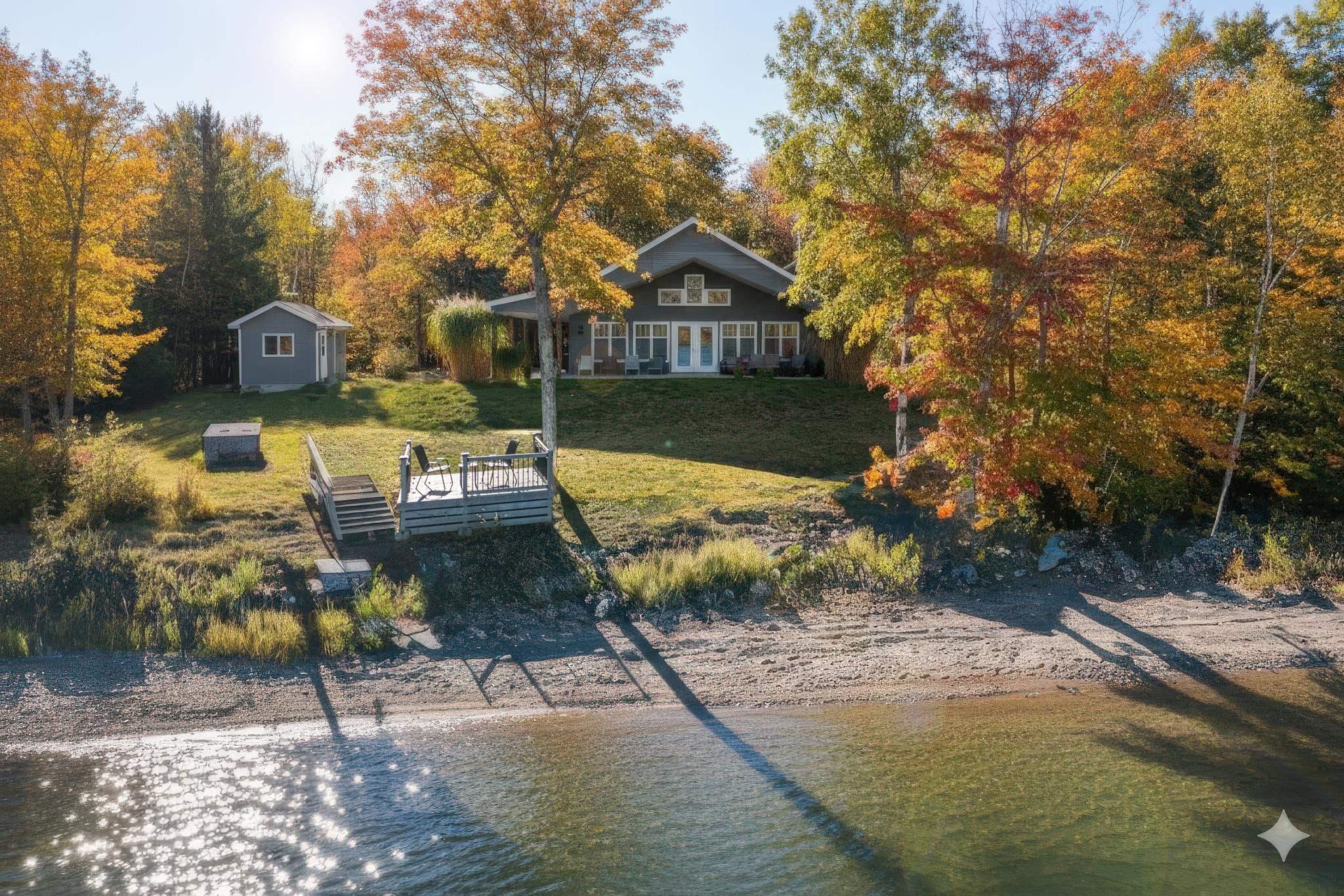 Dock area featuring a yard, a sunroom, and a water view