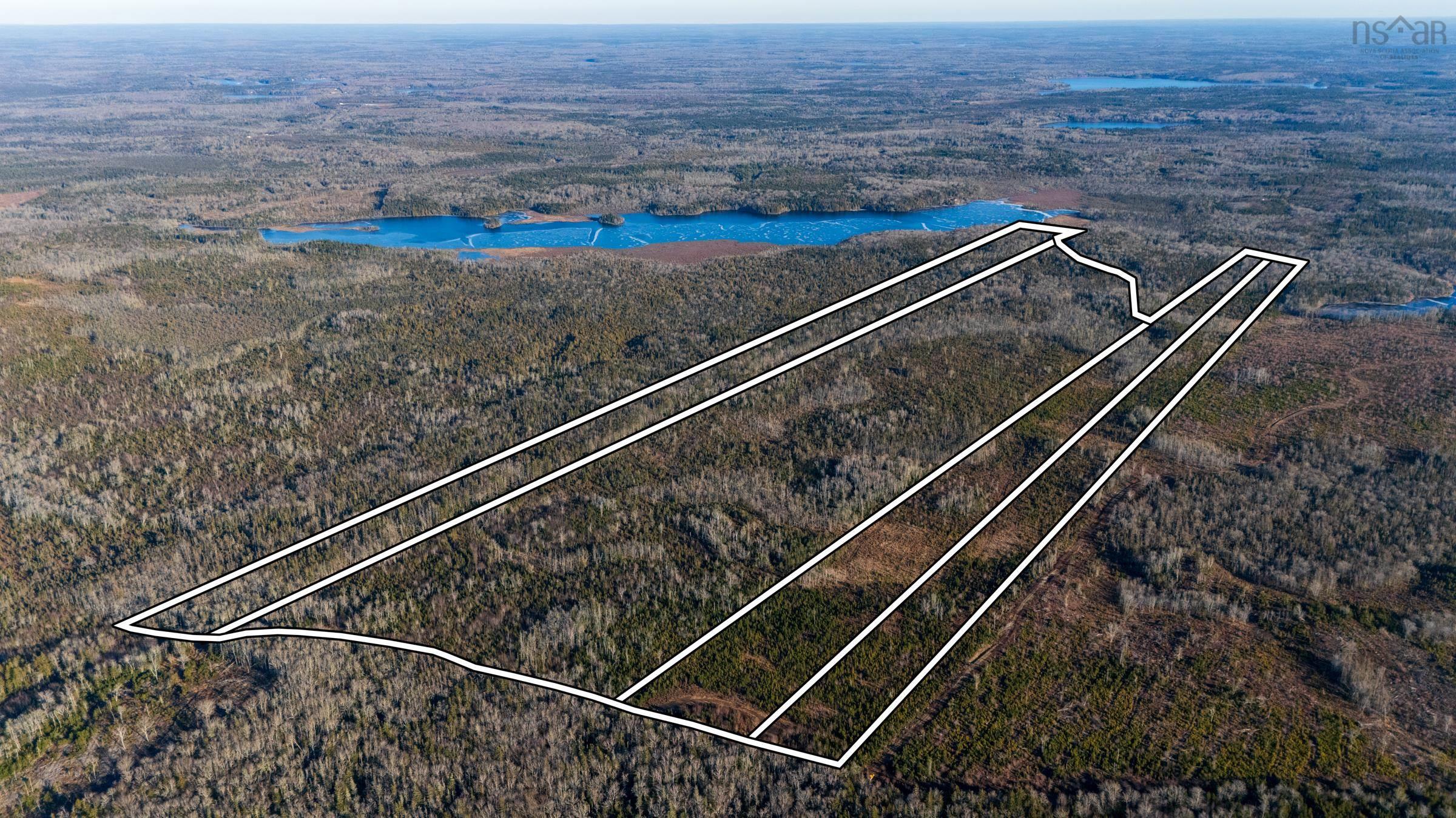 Aerial view of property and surrounding area with property boundaries highlighted and a large body of water