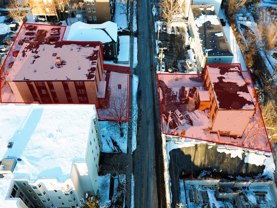 Aerial view of property and surrounding area featuring property parcel outlined