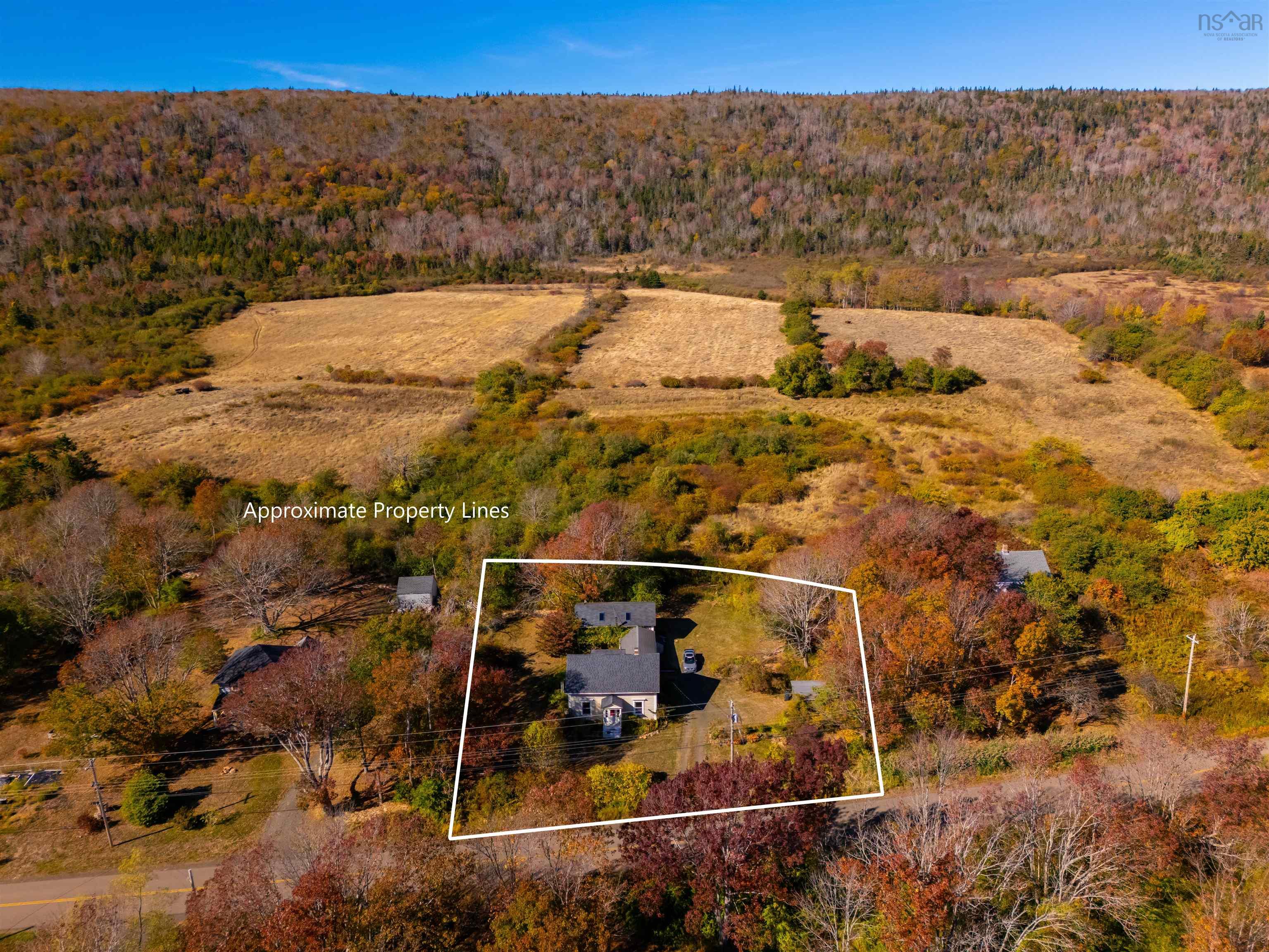 Aerial view of property's location featuring a heavily wooded area and property parcel outlined