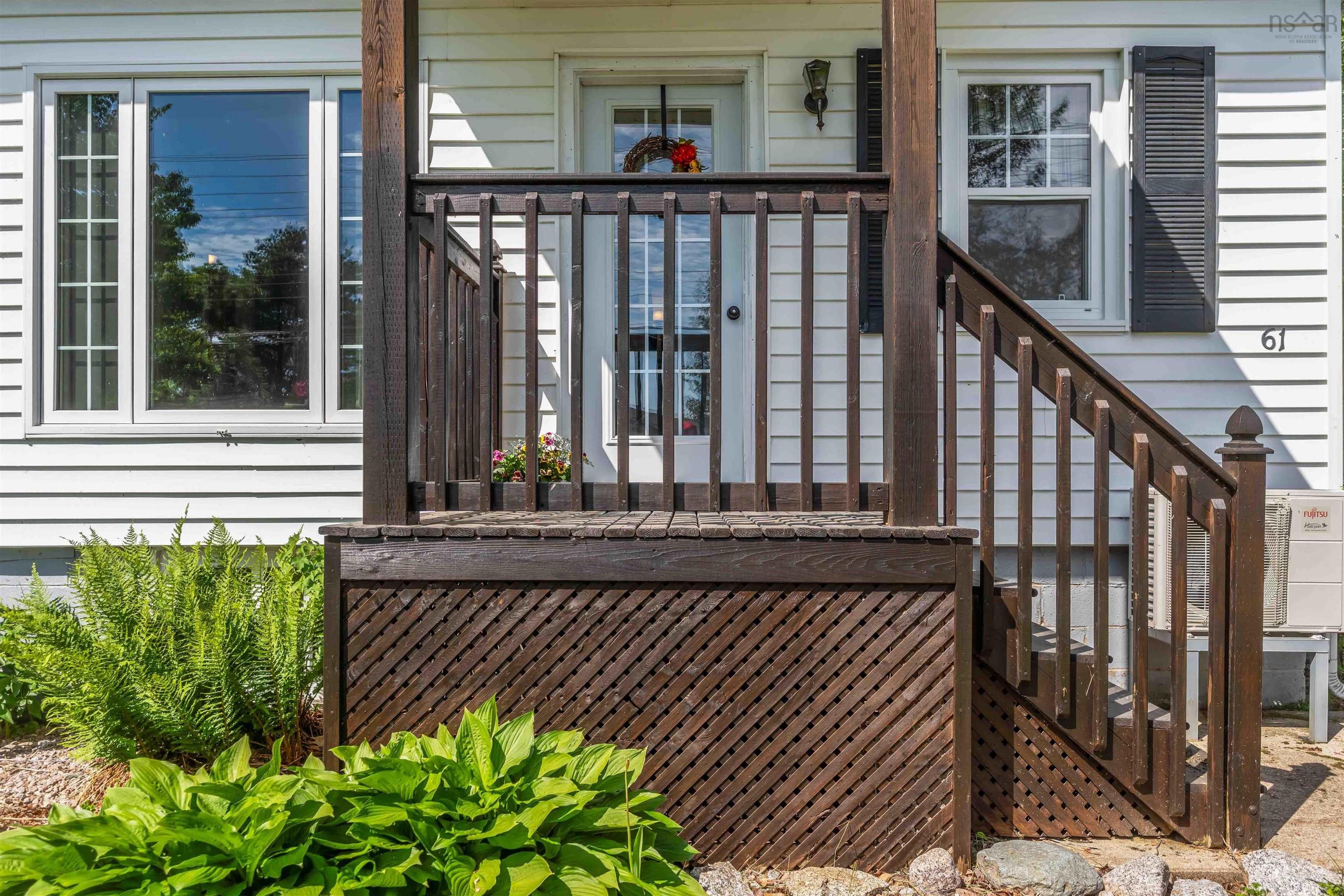 Front entry with dark wood-finish deck and stairs