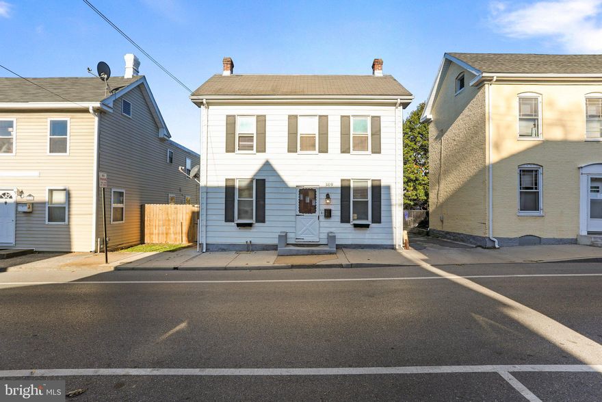 This charming 1888 3-bedroom, 1.5-bath home showcases a wealth of historic features that will captivate your heart. AND is affordable, priced below market value. Original hardwood floors. beautiful brick fireplace (non-working) as well as quite a few updates such as cabinets, countertops, light fixtures, new full bathroom and more.  Watch the fireworks from your porch or walk to many of the activities hosted at the Fairgrounds. This property has a nice size fenced in back yard and deck to entertain or just wind down for the evening outdoors.  OVERSIZED 2 car garage and additional parking and storage.  Come tour your future home and fall in love.