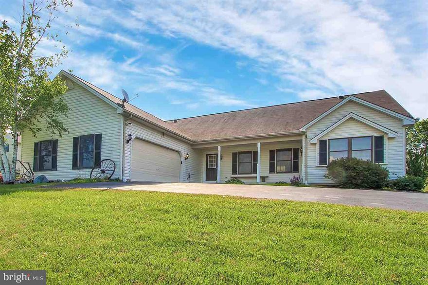 One floor living at its best.  HW floors and vaulted ceilings enhance this open floor plan rancher sitting on 1.4 acres. Lower level with walkout is finished with custom built bar, full bath and a 4th bedroom option.  Sit on the private deck or private front porch and enjoy the surrounding farmland.  Minutes from MD line & I-83