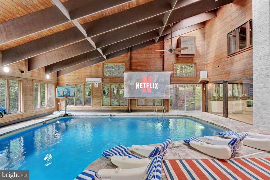 Falling View is a one-of-a-kind property in the Poconos. A historical cabin that predates the surrounding HOA, Falling View has 150+ feet of water frontage on the Bushkill Creek where the mountains fall into waters with breathtaking views in every direction. Originally built in 1930, and a painstaking renovation was completed combining luxury finishes and amenities with character and charm. Upon entering you'll be transported in time allowing your mind to wonder what it would have been like to visit here nearly 100 years ago. The living room has a striking cathedral ceiling of warm wood, skylights, a chandelier and a stone fireplace. The large updated kitchen overlooks the indoor pool with enough seating for everyone. The kitchen features stone counter tops, wall to wall subway tile backsplash, chef's stove, new appliances and white wood ceilings. The indoor pool room spans 1,200 sqft and is the heart of the home with every room having a view of it. The L shaped heated saltwater pool provides endless fun playing games or watching your favorite movie. The pool room is surrounded by windows that provide natural light and a view of the creek that will captivate all your senses. Sliding doors lead to the backyard where you'll find a scenic backdrop for your vacation with the sounds of water and mountain views that rival any in the Poconos. The backyard offers room for more amenities that come with a view and is currently outfitted with a covered hot tub gazebo, picnic table and firepit. It is one of the top 10 highest grossing STRs in the Poconos with  $320,000 in revenue and a 4.96 review score across

The living room cuts an opposing figure with a cathedral ceiling of warm wood logs, skylights, a chandelier and a stone fireplace. Further in you’re greeted by a large, updated kitchen that overlooks the indoor pool and provides more than enough seating for everyone. The kitchen features everything you would want including stone counter tops, wall to wall subway tile backsplash, chef’s stove, all new appliances and white wood ceilings. This is where you’ll gather with friends and family after a day of hiking and fun or in between swimming in your private natatorium. 

The indoor pool room spans 1,500+ square feet and is the heart of the home with virtually every room in the house having a view of it. The L shaped heated saltwater pool is big enough for everyone. Kids and adults alike will have endless fun playing games or watching your favorite movie from the pool. The pool room is surrounded by windows that provide lots of natural light and offers a view of the creek that will captivate all your senses. There are sliding doors leading directly to the backyard deck. 

Out back you’ll find another treasure that this waterfront property provides: A scenic backdrop for your vacation with the sounds of water and mountain views that rival any in the Poconos. The backyard has lots of space for exploring and games and features a firepit, a covered hot tub gazebo and a large picnic table, which are all perfectly placed so you can enjoy the sights and sounds of nature. 

The home is fully permitted with 6 bedrooms and 3 full bathrooms that have all been updated and equipped to provide a comfortable and cozy stay for guests. 

This magical property has provided unforgettable experiences for all who have stayed here for many years. Currently it is one of the top 10 highest grossing short term rentals in the Poconos with approximately $320,000 in revenue over the past twelve months. It has a nearly perfect 4.96 review score across 120+ reviews on Airbnb. Between the convenient location, size and bedroom count, water frontage, mountain views, irreplaceable character and indoor pool  (1 of less than 20 in the Poconos) this home will provide an unmatched experience for guests and stay booked 365 days a year. 

This is a turnkey opportunity to own one of the most lucrative properties in the Poconos steeped in history, character and natural