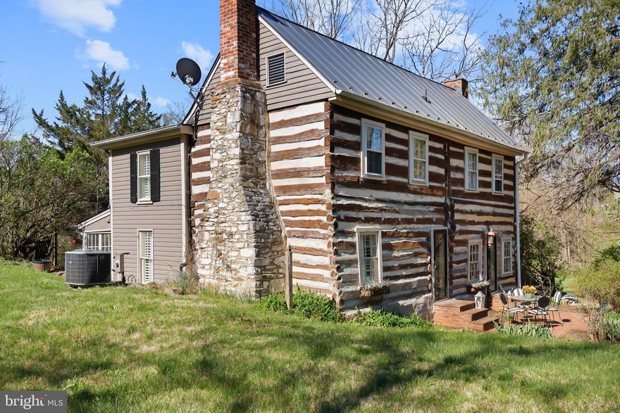 THE MANN HOUSE — A RARE OPPORTUNITY ON 12 ACRES
The Mann House is a 1740 log and stone estate on 12.08 acres in western Loudoun County, with frontage on Catoctin Creek. Built by John Mann on land originally purchased from Thomas Fairfax — cousin of Lord Fairfax — it's one of Virginia's oldest privately held homes, owned by just five families in nearly 300 years.
A Property With Options

Live in it, work it, or build a business around it. Zoned AR1, the property supports agricultural, equestrian, and low-density commercial uses. The land is suited to a hobby farm (goats, llamas, bees), boutique vineyard, farm winery, wellness retreat, bed and breakfast, short-term rental, or boutique wedding venue (subject to Loudoun County approval). Located just minutes from Loudoun's wine trail and Hillsboro's scenic corridor, with rolling pastures, wooded trails, and creek frontage. Historic designation may also qualify the property for state and federal tax credits on approved restoration or preservation work.
The Home

Three bedrooms, 2.5 bathrooms, 2,071 square feet. The original character is intact: hand-hewn log walls, wide-plank pine floors, two massive fieldstone fireplaces, and authentic wood paneling throughout. The kitchen has been updated with Argentine and Brazilian marble countertops, custom cabinetry, stainless steel appliances, and a striking exposed beam overhead — built for gathering. A stone-lined root cellar offers wine storage or a unique historic feature, and the original spring house, summer kitchen, and historic outbuildings remain on the property.
Built to Support a Bigger Vision
The infrastructure has been intentionally sized and updated to support both family living and business use:

Well: 963-foot deep private well connected to an underground river, rated for up to six (6) bedrooms. Big Blue whole-house filtration, flushing filtration system, and new pressure tank (February 2025).
Septic: Designed for a six (6) bedroom residence — providing ample capacity for expansion or commercial use. Holding tank and main tank upgraded with new pump, power, and alarm in Fall 2023.
Electrical: Two 200-amp panels (42-pole main + 24-pole secondary dedicated to kitchen and HVAC), plus Dominion Energy WiFi-monitored smart meter (2023).
HVAC: Two split-system 5-ton heat pumps (one per level), main level replaced 2020, upper level replaced 2023. Ductwork professionally cleaned with UV purification system (2024).
Roof: Standing seam metal on both the main residence and rustic log cabin — a true "install once" investment-grade roofing system.

Recent Updates

New LG stacking washer and dryer (September 2025)
New Bosch dishwasher (December 2025)
New pressure tank (February 2025)
Full plumbing, electrical, and HVAC inspections completed by Appleton Campbell (October–December 2024)
Ductwork UV purification system installed (December 2024)
Bath faucets and shower heads replaced (2023)

The Bottom Line
The Mann House offers the privacy and character of early colonial Virginia with the comfort and reliability buyers expect today — and well, septic, and electrical capacity built for far more than a 3-bedroom home. It's a legacy estate ready for family living, business vision, or both.
Offered at $999,000