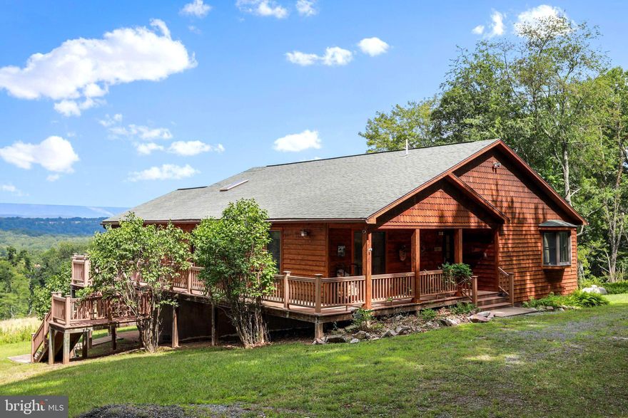 Welcome to Your Mountain Retreat in beautiful Hardy County, West Virginia! Nestled amidst the serene beauty of the West Virginia mountains, this captivating cedar-sided Contemporary style home offers a lifestyle that seamlessly combines modern comfort with nature's tranquility. Situated on a sprawling 20-acre property, this 3-bedroom, 3-full-bathroom haven is the epitome of luxury mountain living. As you approach the property, the elegant cedar siding and distinctive contemporary architecture immediately catch your eye. Step inside, and you'll be greeted by an open, inviting floor plan that perfectly blends natural elements with a sleek design. The heart of the home is a spacious living area featuring a custom wood-burning fireplace adorned with large windows that frame breathtaking panoramic western views. Imagine sipping your morning coffee on the screened deck while the sun paints the sky in vibrant hues or unwinding in the evening with the most spectacular sunsets as your backdrop. The spacious kitchen boasts an ample appliance package, plentiful counter space, and custom cabinetry. Whether you're a seasoned chef or an occasional cook, this kitchen will inspire your culinary creativity. The adjoining dining area offers a perfect setting for intimate family dinners or gatherings with friends—retreat to the generously sized primary bedroom, complete with an en-suite bathroom featuring luxurious fixtures and finishes. Two additional bedrooms provide comfortable spaces for family, guests, or even a home office. A real gem of this property is the expansive 20 acres that surround the home. A harmonious blend of wooded and cleared areas invites exploration, providing opportunities for hiking, picnicking, and outdoor adventures right in your own backyard. Embrace the joys of outdoor living, whether stargazing from the open deck, relaxing by the fire pit, or watching the ample local wildlife in the sunlit clearing. For those who crave additional space, the partially finished basement offers endless possibilities – create a home gym, a workshop, or a recreation area that suits your unique interests. Discover your piece of paradise in Eastern West Virginia – where modern luxury meets the majesty of nature!