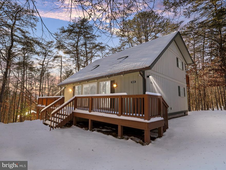 Nestled in the heart of the sought-after Bryce Resort, this stunning home combines rustic charm with modern convenience. The main level features a vaulted wood ceiling with exposed beams, creating a warm and inviting atmosphere in the spacious great room, complete with a stone-front gas fireplace and a classic wood mantle.

Hardwood floors flow through the main living areas, while the kitchen boasts a large island, stainless steel appliances, and an open layout perfect for entertaining. One cozy carpeted bedroom and a full bath are located on the main level, with a convenient laundry area for easy living.

Upstairs, two bedrooms and a bath are complemented by an open overlook to the great room below, enhancing the home's sense of space and light. Step outside to enjoy the peaceful surroundings on the front and side decks, or gather around the fire pit for evening relaxation.

With access to Bryce Resort's amenities—skiing, golfing, lake activities, and more—this home offers the perfect blend of adventure and tranquility. Whether you're seeking a vacation retreat or a full-time residence, this property is ready to welcome you home!