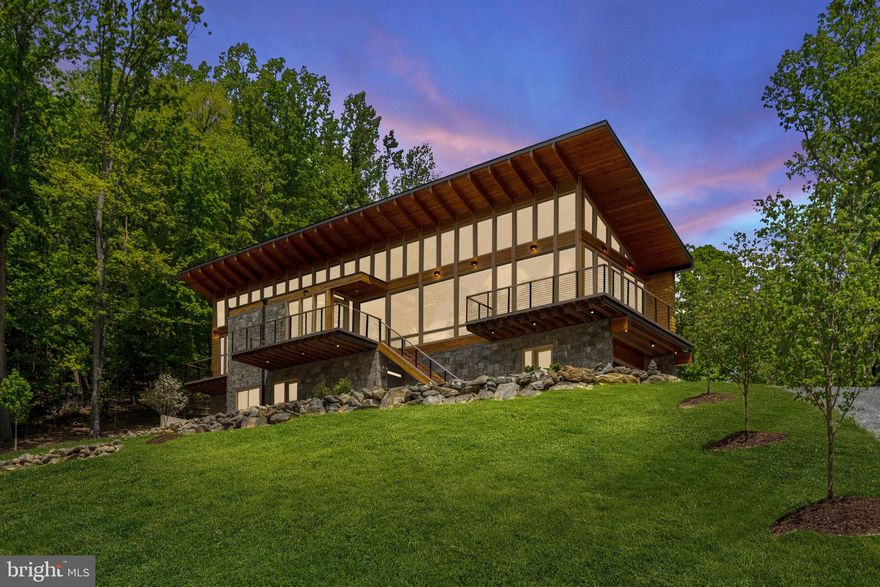 Some properties are just a place apart.  One of those special places is the Red Oak Mountain Retreat.  This 55 acre parcel features gently rising mountain land, a dramatic modernist house well positioned on the landscape, two bold running streams, and trails meandering through the woodlands.   Enhanced by thoughtful landscaping that blends nicely into the forest beyond, Red Oak Mountain Retreat is a true escape from the rest of the world.

RESIDENCE
Sited on a bluff about two thirds of the way up Red Oak Mountain, the residence was created in 2023 by a noted architect as a retreat for his own family.  The house is a sleek modern space designed to showcase the woodland landscape in all directions.  Soothing interiors in neutral colors allow the dramatic wood grain of the hand-selected douglas fir trim to take pride of place.   Modernist architecture with zen like placement of elements make this a calming retreat from the world.  Large windows and high ceilings in all rooms bring the views and allow light to flood each space.  The effect is a light and airy open living space in all rooms.

Views of Bessie Bell Mountain and the surrounding countryside are visible in the winter months, but the rest of the year the house is enveloped in a wall of greenery cascading up and down the mountain.   Rocky outcroppings at the house site have been incorporated into the landscape design and provide a focal point for the house entry way.   On the back side of the house the dramatic  floor to ceiling windows overlook a small valley with forested hillsides and mountains beyond.  The house is an extremely private oasis of calm.  Inside, carefully selected luxury finishes and energy efficient appliances and heating and cooling (including raidant heat in all floors) provide a sustainable living experience at the highest quality.

GROUNDS
The magic of Red Mountain Retreat is the utter privacy of the place.   While the architecture blends seamlessly with the landscape, the mountainside is its own captivating source of pleasure.   Old logging trails radiating from the house site allow for comfortable access to the mountain above and below.   A trail near the property entrance follows along a streambed through the woodlands.  There’s a lot to explore and absorb.

OTHER
Telecom:  Broadband internet is provided by Piedmont Broadband. (Starlink is also available in this location).   Cell phone coverage from T-Mobile and AT&T.

Location:  Red Oak Mountain Retreat is located in Castlteton, approximately 5 miles from the town of Washington, and 8 miles to village of Sperryville.   Approximately 73 miles from Washington, DC.  Travel time to downtown DC is 1 Hour 30 minutes (in low traffic situations).  Approximately 1 hour 20 minutes to Dulles International Airport.  1 hour to Charlottesville.  15 minutes to Culpeper, 25 minutes to Warrenton, and 25 minutes to Front Royal.

Amenities:  The charming small village of Sperryville which is home to Pen Druid Brew Pub, Headmasters Pub, Hopkins Ale Works, Francis Bar, Rappahannock Pizza Kitchen, the Corner Store, a gym, art galleries and shops, and the highly acclaimed The Three Blacksmiths restaurant.  “Little” Washington, the county seat of Rappahannock County is the home of The Inn at Little Washington, Foster-Harris House, Ballards, and galleries and theater. Rappahannock County is a close-knit rural community with excellent theater, concerts, art galleries, wineries, restaurants, and the Shenandoah National Park.