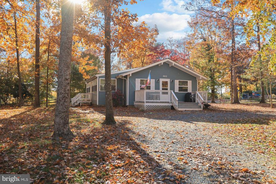 Adorable bungalow on a private lot near the lake in Chesapeake Ranch Estates!! This adorable renovated home has been meticulously maintained and features a new roof, new stove, newer HVAC, renovated bathroom,  a gorgeous stone gas fireplace, washer and dryer, wood floors, front porch and much more! The beamed and lofted ceiling makes the family room oh so cozy, and the sunroom can be used for your morning coffee, a dining room space or even as an extra functioning bedroom! The open concept kitchen has ample cabinets and counter space! There's attic storage and also a shed with lighting and power. This home is just up the hill from Lake Lariat, enjoy fishing from the floating dock just a minutes walk from this cottage.  Enjoy a seasonal waterview of the lake from the spacious backyard and the convenience of community beaches and clubhouse.  Lots of value here in the beautiful space for a great price...book your showing today!