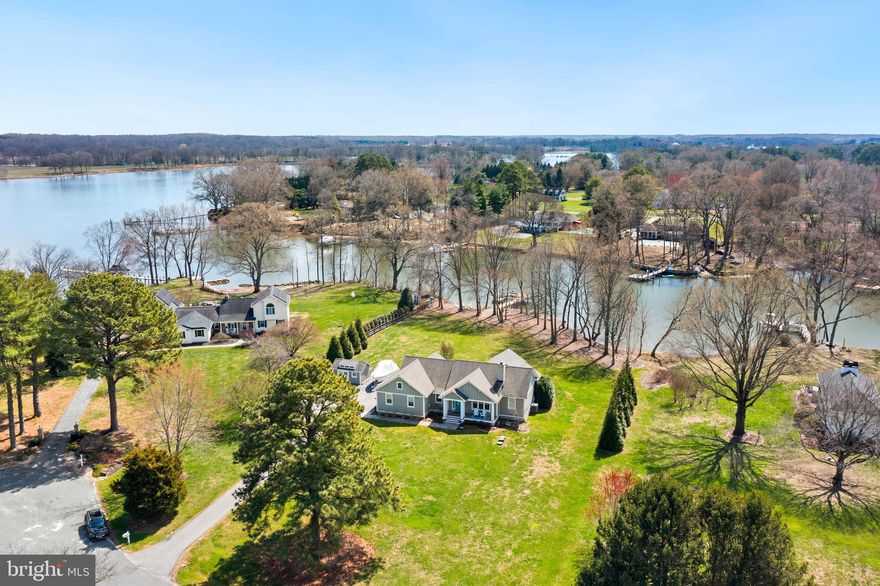 OPEN HOUSE CANCELED. Discover waterfront living at its finest in this immaculate 3-bedroom, 2.5-bath coastal rancher on 1.6 acres along the Wye River. Built in 2013 and fully renovated in 2020, this stunning home blends modern luxury with coastal charm, offering breathtaking river views and an absolutely turn-key experience. Step inside to a welcoming living room featuring vaulted ceilings and a wood-burning fireplace, perfect for cozy evenings. The impeccable kitchen is a chef’s dream, boasting quartz countertops, a propane cooktop, double wall ovens, and an island ideal for entertaining. The dining area includes a custom bar with a beverage cooler and ice machine, making hosting effortless. One of the home’s standout features is the sunroom, where shiplap cathedral ceilings and expansive windows with automated blinds frame stunning river views. The primary suite offers a walk-in closet and a spa-like en-suite bath with heated floors for ultimate comfort. Two additional guest bedrooms share a beautifully designed full bath, while the powder room also features heated floors. A laundry room with a new washer and dryer adds convenience. Additional highlights include custom trim and designer lighting throughout, a finished garage currently used as an office (easily converted back), and a walk-up attic for extra storage. The conditioned crawlspace enhances energy efficiency. Outdoor living is just as spectacular, with a patio, extensive exterior and landscape lighting, a shed with kayak racks, and a riverside fire pit for unforgettable evenings by the water. The rip-rapped shoreline leads to a private dock with a boat lift and an additional slip, providing instant access to the Wye River. No detail has been overlooked in this move-in ready home. Settle in before summer and start enjoying the waterfront lifestyle you’ve always dreamed of!