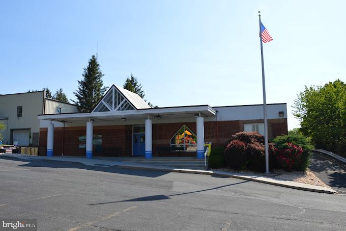 Well maintained commercial building with a spacious layout that will allow for multiple uses. Nicely situated on a corner lot with 25+ car parking. The property includes a child play area that can be maintained, removed or possibly gifted to the adjoining Rotary Park. Large kitchen area within the building. H/P accessible building and rest rooms. Full brick building with lots of windows and a large deck area.
The building has 11’10” clear ceilings in the gym (open area 24’ X 52”) and kitchen (20’ X 22’) as noted on the rough layout. The rest of the ceilings are 9’.