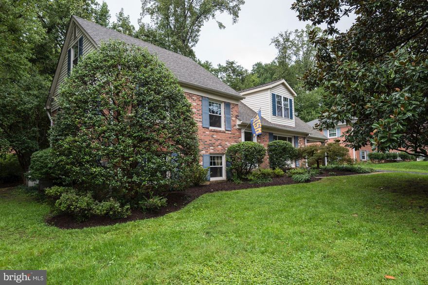 Elegant 5 split-level home w/5 BR, 2 full, beautifully updated BA + powder room. Updated eat-in Kit w/recessed lights, 42  cherry cabinets, new granite counters, tile floor. Formal LR w/fireplace. Separate DR. Fully renovated master suite with spa-like en suite private full bath w/deep soaker tub. Family room. Carport. Big lot w/mature trees. Large newly enclosed screen porch. Easy access to 495.