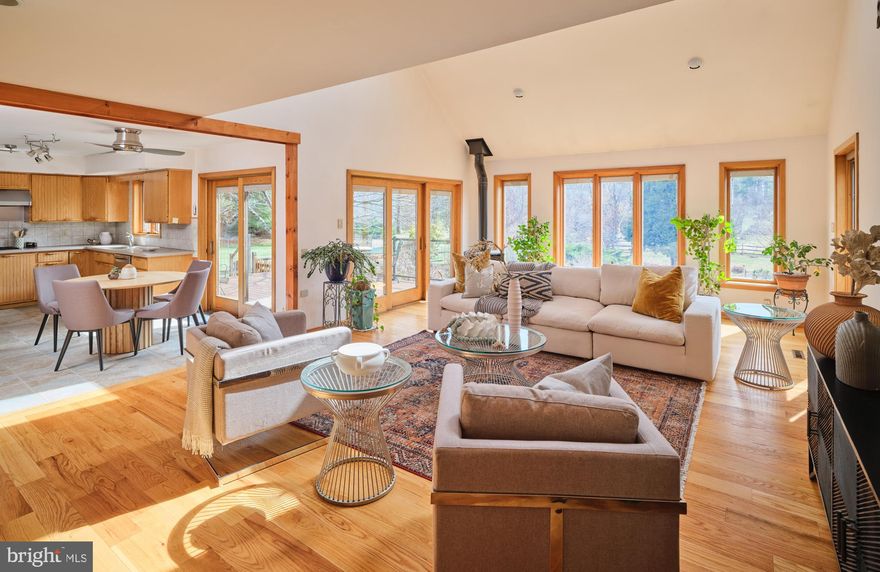 SECLUDED COMFORT, SUSTAINABLE SOPHISTICATION
4 Bedrooms | 3.5 Bathrooms | 5+Acres | Solar| Geothermal Energy. 
Tucked at the end of a long driveway, on over five pristine acres, the house stands as a masterclass in modernist contemporary architecture, updated for a future that demands intelligence alongside style. This Custom-built residence is thoughtfully designed for both intimate gatherings and grand entertainment. The kitchen, expansive great room and dining area easily accommodate a crowd. The Sun filled great room brings the outside in and is equipped with propane stove.  The first-floor primary suite is a peaceful retreat with a spacious, light-filled bedroom and an ensuite bath with summer shower and winter shower/steamer. A soft, neutral palette establishes a sense of openness and harmony across the living, dining and kitchen areas. Panoramic views expand to 360 degrees from every window. Conveniently, from the kitchen and great room , there is access to a generous deck where you can watch the sunrise over your acreage,and is also  ideal for outdoor dining. Stone steps  lead down to a large bluestone patio and secluded pool with spa. The large eat-in kitchen features stainless steel appliances, spacious countertops and abundant cabinetry, delivering both timeless elegance and modern functionality. An airy loft above the great room provides flexible space and leads to three additional bedrooms and a shared bathroom.  The fully finished lower level features an expansive rec room, an exercise room, private office/gaming room , generous closets and a full bath. An additional heat source is provided by a pellet stove.   Engineered for energy efficiency and comfort, this residence utilizes this state-of-the-art geothermal system that leverages the earth’s consistent underground temperature for both heating and cooling, significantly reducing utility costs and environmental impact. The integrated solar panel array is designed to meet virtually all of the home's electrical demand, feeding surplus energy back to the grid and further lowering the carbon footprint. High-performance Pella Design Series windows ensure year-round thermal stability and quiet interiors. Read oak wood floors are throughout. . Additional features include a whole-house UV water filtration system. 
There is an attached two car garage with ample loft space for all your storage needs. A dedicated level 2  EV charger is conveniently located in the garage. 
The Grounds consist of five plus acres and offer a diverse landscape of manicured lawn and  native wildflower meadows. An array of dogwoods, maples, fruit and nut trees as well as ornamental grasses completes the picture. The Pool and spa area is surrounded by manicured landscape, providing privacy. Additional outdoor features include a Greenhouse, set in fenced garden, a large workshop, tractor shed,  bike shed and lean to. Set back significantly from the road, the property provides seclusion while remaining minutes from New Hope and Doylestown. Located within the esteemed New Hope-Solebury School district. Just 70 minutes to New York City, one hour to Philadelphia and 35 minutes to Princeton. This is more than a home; it is a signature property designed for sustainability, comfort and efficiency.