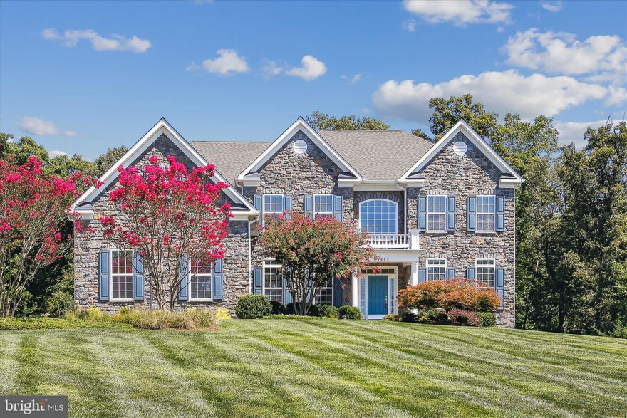 THIS MAJESTIC CANTERBURY MODEL BY CALVERT CUSTOM HOMES SITS ON OVER AN ACRE OF LAND, SURROUNDED BY MATURE TREES FOR A PRIVATE, PEACEFUL SETTING. AS YOU STEP INSIDE, YOU'RE WELCOMED BY A TWO-STORY FOYER WITH HARDWOOD FLOORS, CHAIR RAILING, AND EXQUISITE CUSTOM MOLDING. THE FORMAL LIVING ROOM, FEATURING CROWN MOLDING, PROVIDES AN ELEGANT SPACE FOR ENTERTAINING, WHILE THE DINING ROOM IS ENHANCED WITH CHAIR RAILING, CROWN MOLDING, AND A CHANDELIER MEDALLION, LEADING INTO A CHEF'S DREAM KITCHEN. THIS GOURMET KITCHEN INCLUDES GRANITE COUNTERTOPS, ABUNDANT CABINETRY, A CENTER ISLAND WITH PENDANT LIGHTING, STAINLESS STEEL APPLIANCES, AND TWO GENEROUS WALK-IN PANTRIES. THE INFORMAL DINING AREA IS PERFECT FOR EVERYDAY MEALS AND OFFERS EASY ACCESS TO A TREX DECK, IDEAL FOR OUTDOOR GRILLING. THE FAMILY ROOM, FLOODED WITH NATURAL LIGHT THROUGH A WALL OF WINDOWS, FEATURES A TWO-STORY STONE GAS FIREPLACE, CREATING A COZY AND INVITING ATMOSPHERE. JUST OFF THE FAMILY ROOM, A SCREENED-IN PORCH PROVIDES A RELAXING SPOT FOR OUTDOOR DINING AND ENJOYING THE SURROUNDING NATURE. THE MAIN LEVEL ALSO INCLUDES A DEN WITH DOUBLE GLASS-PANELED DOORS, MAKING IT AN EXCELLENT SPACE FOR A HOME OFFICE. UPSTAIRS, A CURVED STAIRCASE LEADS TO THE LUXURIOUS PRIMARY SUITE, COMPLETE WITH A GAS FIREPLACE WITH DENTAL MOLDING, AND A SPACIOUS EN SUITE BATHROOM. THE PRIMARY BATH OFFERS TILE FLOORS, SEPARATE SINK VANITIES WITH GRANITE COUNTERTOPS, A SOAKING TUB, A STANDALONE SHOWER WITH DUAL SHOWER HEADS, AND AN EXPANSIVE WALK-IN CLOSET. FOR CONVENIENCE, THE PRIMARY BATH CONNECTS TO A LAUNDRY ROOM EQUIPPED WITH A FRONT-LOADING WASHER AND DRYER, AS WELL AS AN ADDITIONAL LARGE WALK-IN CLOSET OR DRESSING ROOM. THE UPPER LEVEL ALSO INCLUDES TWO ADDITIONAL BEDROOMS SHARING A FULL HALLWAY BATH AND A FOURTH BEDROOM WITH ITS OWN PRIVATE BATH AND WALK-IN CLOSET. THE FINISHED WALK-OUT LOWER LEVEL FEATURES A SPACIOUS RECREATION ROOM, A LARGE UNFINISHED STORAGE AREA, AND A GUEST BEDROOM WITH A SITTING AREA AND ACCESS TO A FULL BATHROOM. OUTSIDE, A CUSTOM PAVER PATIO OFFERS ANOTHER BEAUTIFUL SPACE FOR RELAXATION. THIS HOME IS AN ENTERTAINER'S DREAM, WITH A SURROUND SOUND SPEAKER SYSTEM AND LUXURIOUS DETAILS THROUGHOUT, MAKING IT AN EXTRAORDINARY PROPERTY.