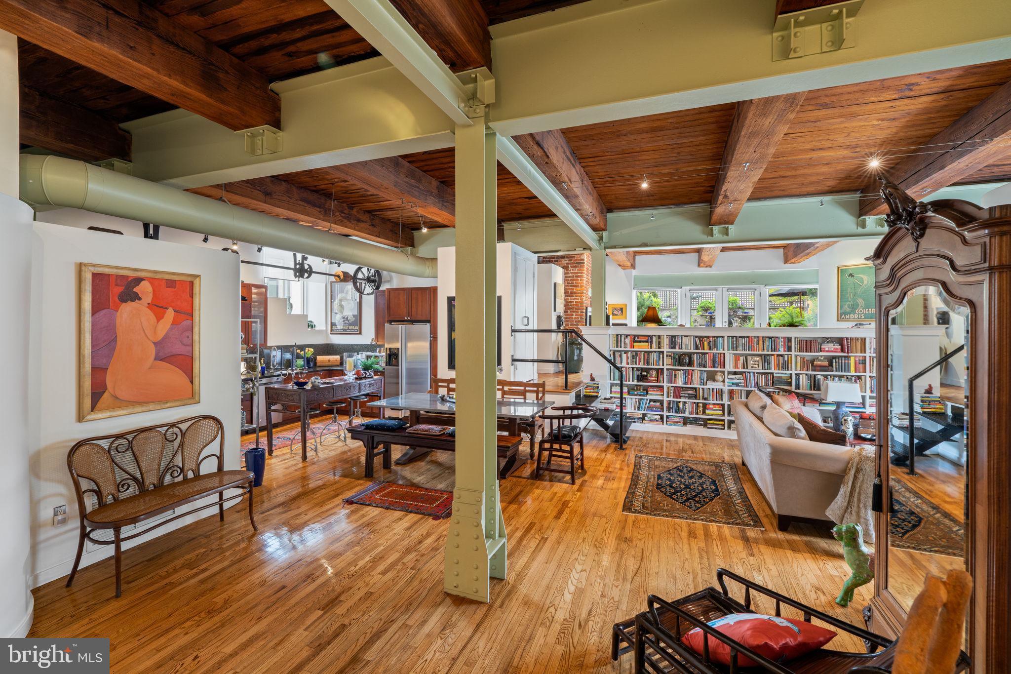 A Beaux Art Jewel on the Premier Block of Queen Village/Bella Vista
Once a bustling warehouse trading in imported breads, olives and oil, now an historic residence featuring four unique loft-style condominiums rarely offered for sale, the Coroneos Bros. building is a once-in-a-lifetime opportunity to own the best of the industrial age and modern urban living.
Steeped in character, rich in architectural detail, and spanning a full-floor, Unit 2 is an expansive 2,351 square-foot, two-bedroom, 2.5 bath home offering the openness of a loft and the refinements of an apartment, perfect for entertaining as well as thoughtfully appointed ease.
Step off a private elevator into a sweeping space swimming with natural light from all four exposures. Massive, exposed beams, oversized windows, soaring ceiling heights, original cast iron columns and brickwork are juxtaposed against a modern edge. An old pulley system above the kitchen has been preserved and repurposed as sculptural housing for modern track lighting. Tucked away in the former freight elevator an elegant study. A library the length of the great room. Beautiful hardwood floors run throughout.
Industrial steps float down to bedrooms, and up to a family room opening onto a sprawling private garden gorgeously landscaped and generous enough to seat eight dining al fresco. Truly an impossible-to-find oasis in the city.
Amenities:
Private Deeded Elevator
Deeded garage parking
Oversized deeded storage room
In-Unit Alarm System
Security in Garage and Common Areas
Meredith Catchment
Ideally situated in a neighborhood teeming with restaurants and coffee houses, adjacent to Society Hill, an easy stroll to Washington Square and Old City, and steps away from the Italian Market, and the urban cool of 4 th Street shopping, this is city living at its best.