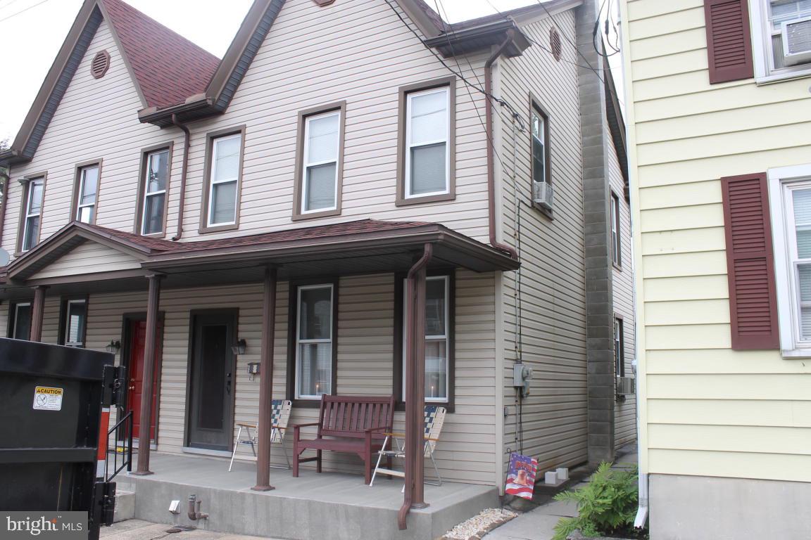 Semi with 3 private bedrooms, over-sized 2 car garage with electric & walk-up steps to storage above. Replacement windows throughout home, appliances remain, updated electric, newer roof on house & garage. Attic could be finished into a 4th bedroom. Lovely yard with covered porch & patio area.