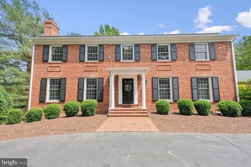 Privately situated on a magnificent 2-acre lot framed by mature trees and lush landscaping, this gorgeously updated Colonial delivers elevated living with effortless grace. A circular driveway welcomes you to a residence that perfectly balances classic sophistication with modern luxury.
Light-filled interiors are grounded by rich hardwood floors and anchored by three wood-burning fireplaces, creating an ambiance that is both warm and refined. The heart of the home is a fully renovated gourmet kitchen, outfitted with top-of-the-line stainless steel appliances (42-inch SubZero refrigerator, two built-in SubZero beverage fridges, Miele dishwasher, 48-inch Wolf range and convection oven and Wolf microwave), gleaming quartz countertops, and custom cabinetry—designed for the serious chef and the stylish host alike. Entertain with elegance in the banquet-sized dining room, unwind in the relaxing family room, or enjoy serene mornings on the screened-in porch overlooking your private outdoor oasis. The main-level office, tucked away behind European antique carved wood doors, offers a stunning blend of character and function—perfect for remote work or quiet study. A generous deck, flagstone patio and sparkling swimming pool (with an automatic electric safety cover and outdoor sound system) offer the perfect backdrop for al fresco dining and private sun-soaked afternoons. Upstairs, the private quarters include five spacious bedrooms and three beautifully updated bathrooms, providing luxurious accommodations. Each space is thoughtfully designed with comfort, flow, and functionality in mind.
The walkout lower level is designed for leisure and lifestyle—featuring a recreation room, wood-burning fireplace, wet bar, a full bathroom, and an expansive storage room. Wrapped in natural privacy yet minutes from everything, this home offers the rarest of combinations: timeless architecture, top-tier amenities, and serene, resort-style living.