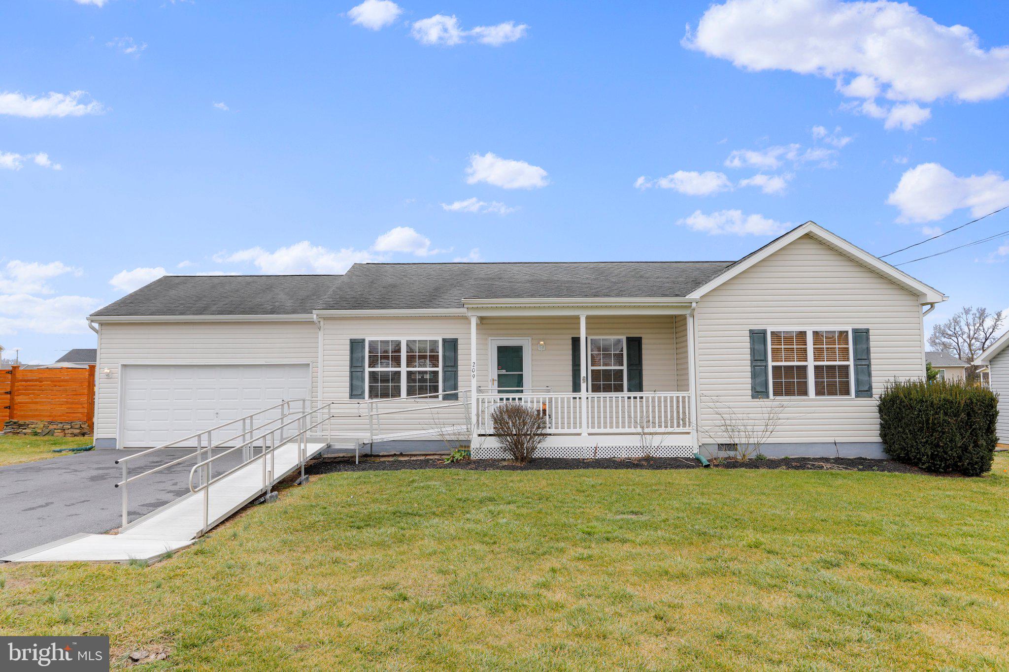This well-maintained 3 bedroom, 2 bath ranch home has all the features for comfortable, main-level living. The main living areas offer an open floor plan, allowing for a seamless flow between the living room, dining area, and kitchen. The primary bedroom has 2 lighted closets and a full bath that includes a soaking tub, shower, and double sinks. This home is complete with an oversized attached 2-car garage that has enough room for a workshop and is furnished with heat and water.
The sunroom was added in 2021. Large fenced yard with storage shed.
Located in Bunker Hill, WV, this home provides convenient access to a range of amenities. Shopping centers, restaurants, and recreational facilities are all within proximity, ensuring you have everything you need just moments away. All sizes are approximate.