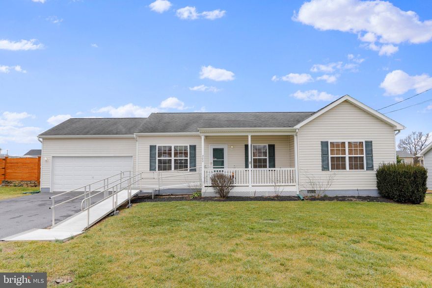 This well-maintained 3 bedroom, 2 bath ranch home has all the features for comfortable, main-level living.  The main living areas offer an open floor plan, allowing for a seamless flow between the living room, dining area, and kitchen.  The primary bedroom has 2 lighted closets and a full bath that includes a soaking tub, shower, and double sinks. This home is complete with an oversized attached 2-car garage that has enough room for a workshop and is furnished with heat and water.    
The sunroom was added in 2021. Large fenced yard with storage shed.
 Located in Bunker Hill, WV, this home provides convenient access to a range of amenities. Shopping centers, restaurants, and recreational facilities are all within proximity, ensuring you have everything you need just moments away. All sizes are approximate.