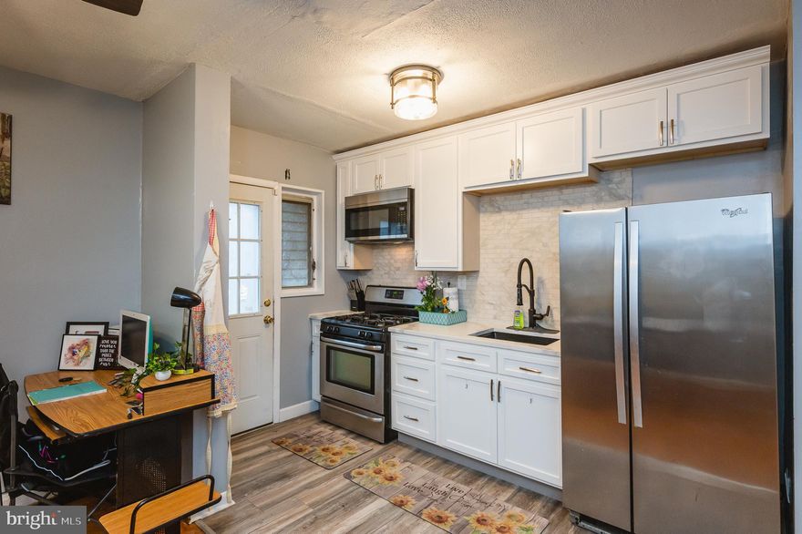 PRICE REDUCED!!!! On this welcoming open concept Semi-detached home. This home offers beautiful wall to wall hardwood flooring  except in the NEWLY renovated kitchen. This kitchen has new white cabinets, Quartz countertop with a subtle backsplash to match. Get comfortable  in the large master bedroom with ample closet space. The second bedroom is also spacious with a large walk in closet. RENOVATED BATHROOM from floor to ceiling. Enjoy the new bright light fixtures and ceiling fans throughout the house. It doesn't stop there!!! This house has a large fully finished lower level ready to be your large family room or possibly a 3rd bedroom. There is additional space in the basement laundry area for storage. The exterior of the house has a fully fenced-in  large yard at the rear for activities and more. The side of the house has a wood fenced in yard for you to sit and enjoy the nice quiet neighborhood. THE SELLERS ARE OPEN TO ALL REASONABLE OFFERS! Very motivated!