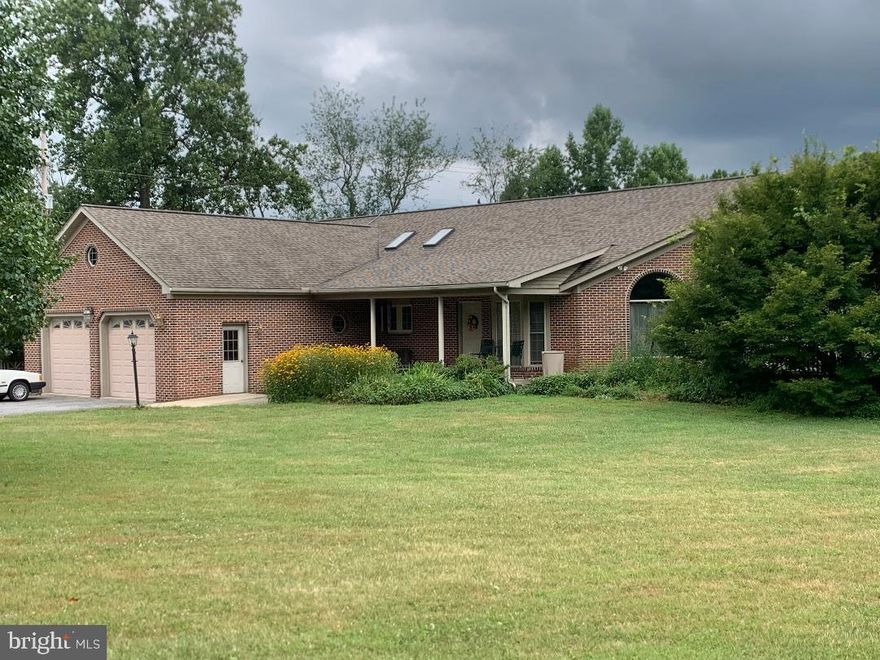This amazing huge all brick home is just what you are looking for:  A very large house with lots of garages, tons of storage and a plethora of parking spaces and all on 2.5 acres in the country.  The home offers soaring ceilings, large open living room/dining room/great room, 3 bedrooms and 1.5 baths, a big laundry room and an oversized 2 car garage, a concrete front porch and 2 decks all on the main floor.  The lower level offers a huge open family room with a full bath.  It could be used as a 4th bedroom or in-law suite/nanny suite.  Currently the lower level is used as an Air BNB, there's an enclosed room for an office area  or locked storage closet/room (no window), a big walk-in open closet room currently used a bedroom (no closet rod or shelving but easy to add), a big unfinished storage/utility room and two huge integral garages one with a taller door than the other, one with an automatic garage door opener. It's completely walk out with plenty of parking. There's also a patio off the family room and a large, long hardscaped wall with a cave room in it (formerly used as a wine cellar).  The 2nd half bath is not in the lower level it is in the detached garage. There's a detached garage/shop with 3 garage doors, 2 of which are extra-large, one of those is 84" and can accommodate a large RV.  The shop is currently a county approved Volvo automotive repair shop.  Seller believes a new buyer wanting to do a business would need to apply for their own approval for their business. There's also a very long storage shed.  This amazing property has 40 solar panels (leased) installed 2014, a new 50 yr architectural roof installed in 2018.  There's a huge sunken hot tub in one of the bedrooms, however it's been drained due to a leak. The home and appliances have not been updated; it could use fresh paint, new carpet and any other updates a new buyer would want.  Wood stove / furnace in garage used to heat house as additional option.  is not currently working as a home furnace.  It can heat some in garage. The home is priced accordingly.  A 1 yr home warranty will convey to a buyer.  Hot water heater new in last couple months.  Well pressure tank replaced in 2015.  Foot valve on well pump replaced 2010.  Located just down the hill from the Appalachian Trail and halfway between Frederick & Hagerstown.

Please Note the sale does not include the Volvo automotive repair business, with all mechanical parts, equipment (lifts wheel balancer etc.) & vehicles. However, seller will be selling the contents of the business at a upcoming auction to be determined soon.