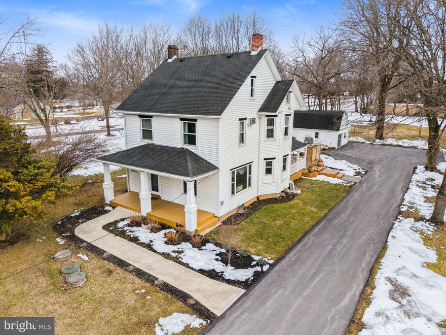 Once a classic farmhouse, now entirely redefined, this fully reimagined home on one acre within the Nazareth Area School District blends timeless charm with today’s luxury finishes and refined design. The welcoming foyer opens to an expansive living and dining room anchored by a wall-to-wall bay window that fills the home with natural light and creates a warm, inviting atmosphere for gatherings. The remodeled eat in kitchen is designed for the modern host, featuring a generous center island, quartz countertops, coffered ceilings, professional stainless appliances, and an electric fireplace that beautifully connects the kitchen and living areas for seamless entertaining.
A dedicated den or office with built ins provides the perfect work from home solution or quiet study space. The main level also includes a thoughtfully placed half bath, laundry room, and mudroom with side deck access and mini split cooling.
Upstairs, the primary suite is a true retreat with a walk in closet and spa inspired bath complete with soaking tub, oversized walk in shower, and double vanity. Two additional bedrooms share a brand new full bath. The third floor offers two heated rooms ideal for future bedrooms, creative studios, or flexible living space.
The basement features a wide staircase and enclosed exterior entrance, offering practical storage and potential for hobbyists, contractors, or future expansion.
Outside, enjoy a detached two car garage and a barn style one car garage with workshop and second story,  perfect for car enthusiasts or anyone craving extra workspace. The landscaped backyard retreat showcases a spacious deck overlooking mature greenery, multiple seating areas for entertaining, and an inviting front porch that completes the picture.
For buyers seeking room to roam, refined updates, and a property that makes a statement, this home delivers presence, versatility, and lasting value.