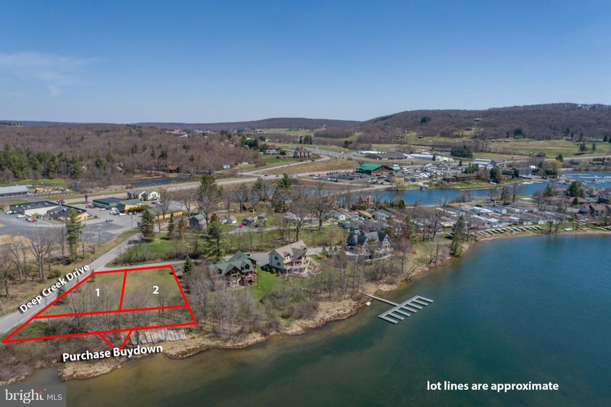 Lakefront Lots 1 & 2 John Young Parkway in McHenry  are side by side  Lakefront lots w/ 199' of Lake frontage along the shores of Deep Creek Lake.  Serviced with Public Water & Public Sewer in a Town Center (TC) Zoning District, your ability to build up to a 8 Bedroom home is available. Lot 2 has a dedicated 4- slip common dock system per the original subdivision guidelines. Physical dock system and storage building included. No HOA but annual dock slip  permit fees of $640.00 ($160.00 per slip)  do apply.  Survey plat available.