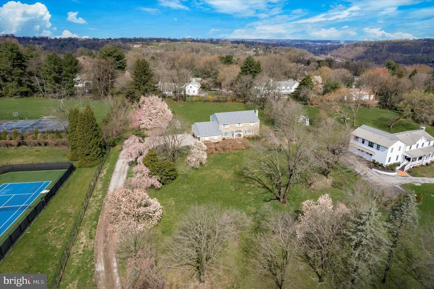 Welcome to 1530 Briar Hill Road, a well-maintained home set on over 1.8 acres, nestled along a serene, tree-lined street in close proximity to all the attractions of the Main Line area. The property welcomes you with mature trees and a spacious front yard as you approach via the private driveway. Upon entering the foyer, you're greeted by handsome hardwood floors and a classic Colonial entrance, complete with a powder room. The expansive living room features a wood-burning fireplace, built-ins, and abundant natural light streaming in through large windows. Adjacent, the formal dining room offers access to the generously sized eat-in kitchen, boasting granite countertops and a sizable eating area overlooking the expansive backyard. The family room, equipped with a bar, opens onto the updated flagstone/brick patio, perfect for outdoor dining. Completing this level is a spacious laundry/mudroom with access to the attached two-car garage, which also offers plenty of additional storage. Upstairs, hardwood floors flow throughout the second level, featuring a large primary suite with a walk-in closet and en-suite bathroom boasting a double vanity and stall shower. Three additional bedrooms, all with ample closet space and natural light, share a large full hall bathroom with a double vanity and tub/shower. The expansive finished lower level, with a large bar, presents a versatile space ideal for a recreation room, home gym, or entertainment area. This property is a must-see for those seeking a home with abundant outdoor space in a convenient, sought-after location.