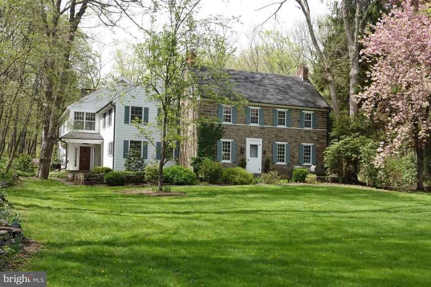 Nestled in the verdant woodlands and fertile farmlands of Upper Bucks County is a classic stone farmhouse full of heart and history. Turn down the winding driveway, over the creek that babbles beneath the tall trees, pass the stone bank barn and emerge at an emerald green lawn that stretches before you, revealing an elegant home tucked into the valley. This is the perfect marriage of old and new, of rustic charm and modern convenience. This is Spondon. Named for a small village in England, this c1825 stone house has been expanded to become a spacious and inviting home. A stone patio graces the front of the house, and leads to a large dining room with deep window sills, a built in floor-to-ceiling wood hutch, and two wood-burning fireplaces. The eat-in kitchen is the heart of the home, with exposed wood beams, wood cabinets, stainless appliances, and an open-air pantry. Close by is a central foyer that opens to a grand living room, with a large fireplace flanked by benches, and built-in bookcases. Upstairs, the luxurious master suite features yet another fireplace, walk-in closet, and master bath with a Japanese-style soaking tub. A private master balcony looks out over the creek and back yard, and is the perfect place for morning coffee. Three more bedrooms complete the second floor, along with two full baths, and a finished attic room boasts a walk-in closet for extra storage.  A rear patio gives way to an in-ground pool, just right for hot afternoons or warm summer evenings. The gravel driveway has two parking areas for easy access to both the grounds and the house, with room to accommodate family as well as guests. A 4-story stone bank barn once held horses on the ground level, while upper levels feature a glass wall entry and a spacious and versatile interior with offices, workrooms, a cedar closet, and multiple loft areas.  For the adventurous, 88 acres of woods and fields invite exploration and discovery, with endless opportunity for hiking or recreation. Hidden away in coveted Tinicum Township, Spondon is nevertheless in easy driving distance to town centers, and just a few short minutes from scenic River Road. Classic Bucks County living at its finest, in the most enchanting of settings, Spondon is a timeless yet unique property.