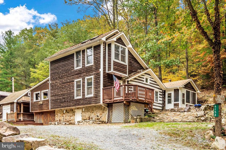 Offer deadline Wednesday Nov. 1st at 3:00 pm. Welcome to 7 Gables Lodge! Super cool place to get away from it all! Minutes to Frederick. Gateway to the Catoctin Mts.. Renovated log cabin with main level owners suite addition. Top level has a loft/bedroom with cathedral ceiling skylights and full bath. Sleeping loft over living room! Cozy up by the wood stove on those cold winter nights. Covered porch with room for HOT TUB. Tiki bar/ shed a few steps down off the enclosed porch. Did I mention a fire pit where you can hear the stream across the street? Mountaindale is a cozy community of log cabins tucked away at the base of the Catoctin Mts. with direct access into Frederick Watershed.  This property location qualifies for USDA 100% financing.
An offer deadline will be set once we receive an offer. Sellers reserve the right to accept an offer at any time.