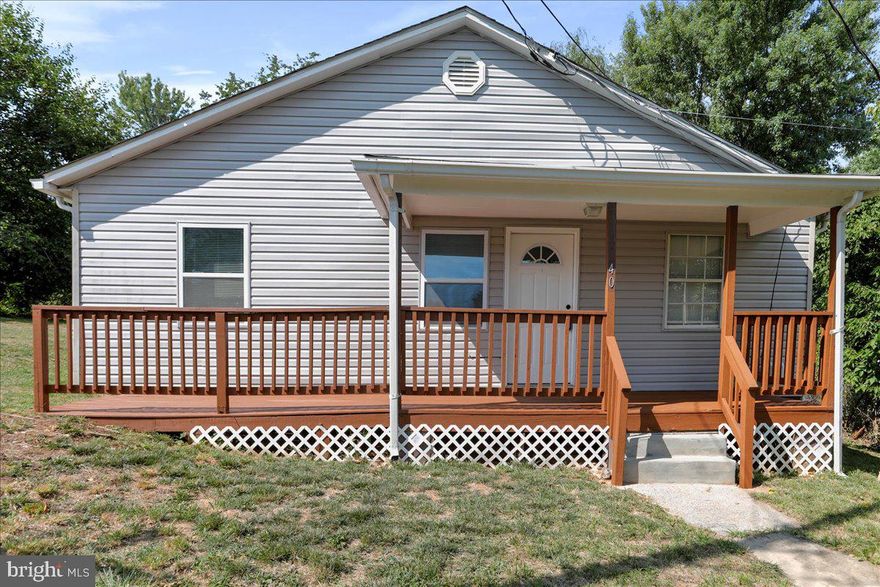 Experience true one-level living in this affordable three bedroom Rancher on the outskirts of Ranson! Fully renovated in 2022, this lovely home boasts a spacious living room, a modern kitchen with granite countertops and stainless steel appliances, plus a separate dining room. Enjoy the peace of mind that comes with the two year new HVAC system and a UV light for clean water. The home features ceiling fans, tiled shower/tub, and a combined laundry/storage room. Relax on the partially covered front porch or step outside to the rear deck that overlooks a deep fish pond with waterfall containing a variety of fish including coy, goldfish, catfish, blue gill, and minnow. The double lot is adorned with fruit trees and bushes, including peach, pear, plum, mulberry, blackberry, raspberry, and grapes. Nestled on a quiet, dead-end street, this property backs to pasture land, offering a sense of peace and tranquility. Property is in need of septic work and is being sold "AS IS" , CASH OR REHAB LOAN ONLY.