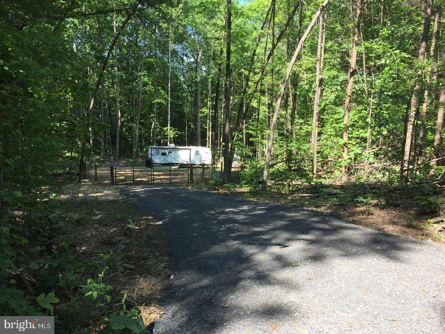What a great getaway! Just under 3 acres and literal minutes from Lake Anna! Own your own camping site - camper (has been used less than 10 times by current & previous owner) with 1 slideout , already in place! NEW drilled well and shed! Beautiful spot with an abundance of privacy! 3 bedroom perc , for when you're ready to build your dream home.  Immediate area is fenced in for privacy or for pet enjoyment.  Internet service available.