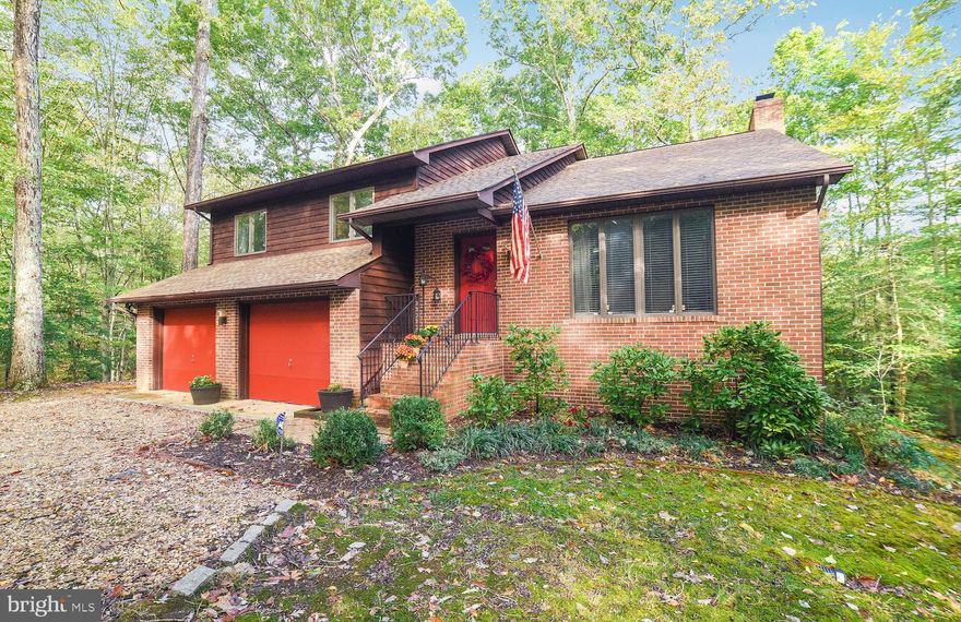 This unique hidden gem of a home is located on nearly 4 private acres in Paw Paw Hollow of Breton Bay.  Well maintained contemporary style home with 3 bedrooms and 3 full baths.  Upgraded kitchen with new granite countertops and stainless appliances.  New hardwood floors in living room, dining room and kitchen.  New carpet in lower level rec room, bedroom and stairs. New HVAC 2019 and roof only 6 years old!  If looking for privacy and a peaceful setting, look no further.  Convenient to Breton Bay Golf and Country Club (memberships available) and community beach ($50 annual membership). Oversized 2 car garage and unfinished lower level for extra storage.  No HOA. Call today for appointment