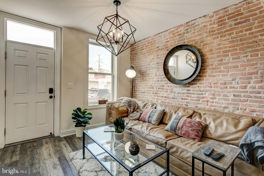 Gorgeous end of group row home ready for the most discerning buyer. Craftsmanship and care shows throughout and into the smallest of details. You'll love living here! Enjoy entertaining on your rear deck all year long. It offers plenty of space for a grill and outdoor dining set.   The pergola is perfect for hanging ferns or other greenery. There is direct access to city owned green space if you have any furry family members that might want a short walk on real grass.  Begin your morning in a dream kitchen. Get coffee brewing and sit at the dining room table while you read the paper. There is so much storage space with this cabinet design! Come check out these built-ins with soft close hinges and you won't want anything else! As guests come to visit they'll be greeted by the professionally repointed exposed brick walls that blend seamlessly with the industrial metal staircase and gorgeous flooring. Looking for an open layout? Wow.  2 upper bedrooms share a beautifully tiled bathroom with dual vanities. Each room has its own ductless mini split hvac system which provides zoned heating and cooling exactly where you want and need it. Closet space is abundant.  The fully finished basement provides great space for a home office or lounge area that could also provide friends and family a cozy overnight stay. It does have a full bathroom accented with designer mixed metals that your guests are sure to admire. Locust Point offers easy access to Rt 95 and downtown buses as well as water taxis for the Inner Harbor commuter. Ft Mchenry and Latrobe Park are just a  short jog or bike ride away and you can even walk to numerous grocery stores. The area features highly rated dining options and numerous corner shops. Don't miss this opportunity in such a terrific area.