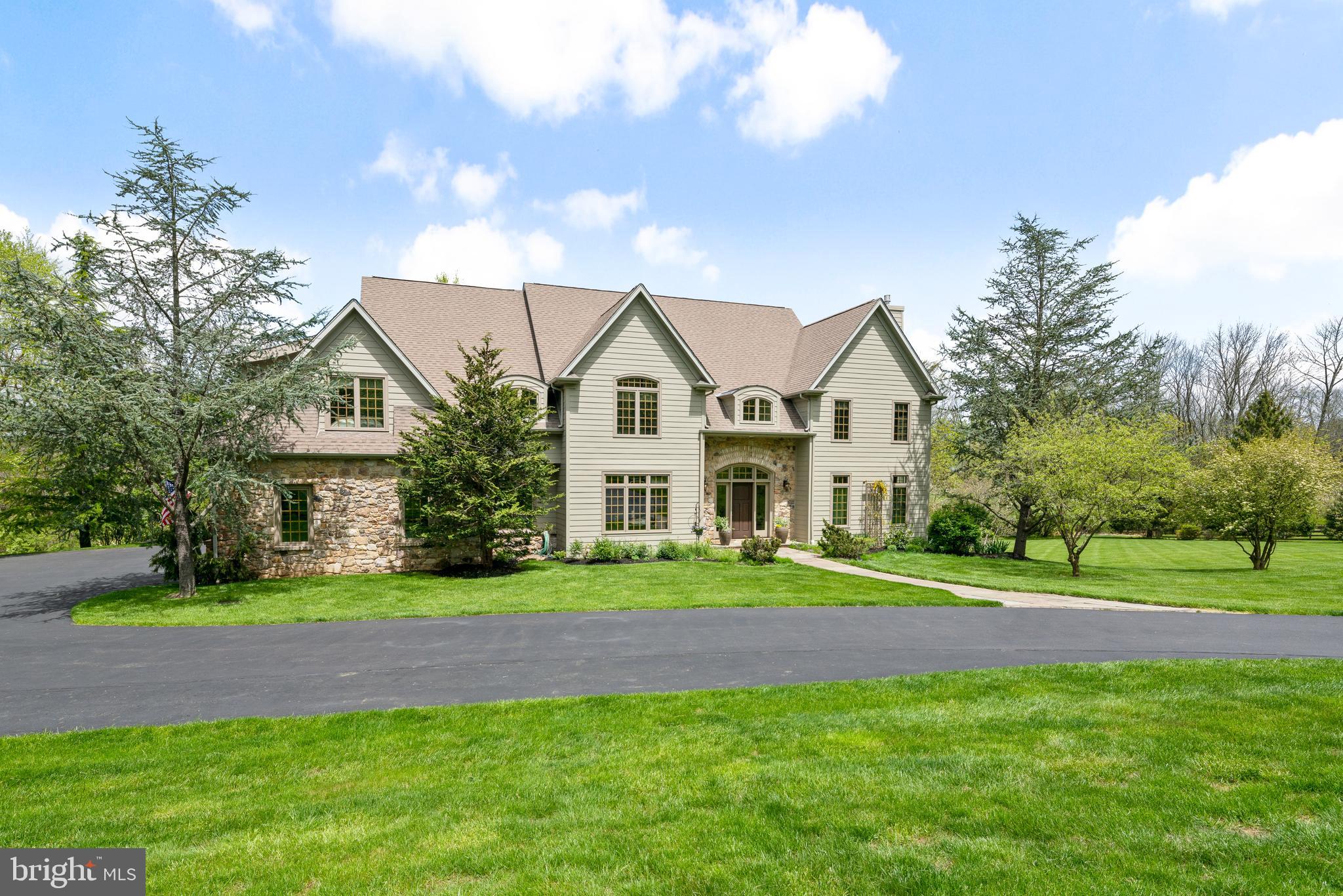 Situated on a private drive in prestigious Solebury Township, nestled among an exclusive boutique enclave of highly desirable and beautiful custom homes sits 105 Wynfield Lane. Be inspired by the magnificent setting and the natural beauty that abounds in this special and unique setting. This five bedroom and four one-half bath home with three fireplaces and walk-out lower level sits on 2.74 acres of lush specimen plantings and landscaping. Take in and admire the extraordinary craftsmanship and attention to detail that resonates throughout this gracious residence built by well respected custom home builder Richard Zaveta. Fine architectural elements, warm natural woods, exquisite millwork adorn this beautiful home. The wonderful open and flowing floor plan with formal yet comfortable living spaces is perfectly suited to meets the needs of vibrant family life or gracious entertaining. The family room with cut stone, wood burning fireplace which was built from stone excavated from a local quarry on the Delaware and the designer kitchen serve as the center of activity for the active family. The master suite is a private refuge designed for comfort and calm with a master bath that pampers to your every need and desire. The finished lower level with ground floor elevation, walk-out, wet bar and open design is perfectly suited for family living and indoor or outdoor entertaining. An Asian inspired backyard oasis complete with a stunning black bottom swimming pool, 2 tier stone patio, waterfall and koi pond make this a most inviting surrounding for reflection time, family gatherings or entertainment delight. Schedule your exclusive showing before this amazing home slips away.