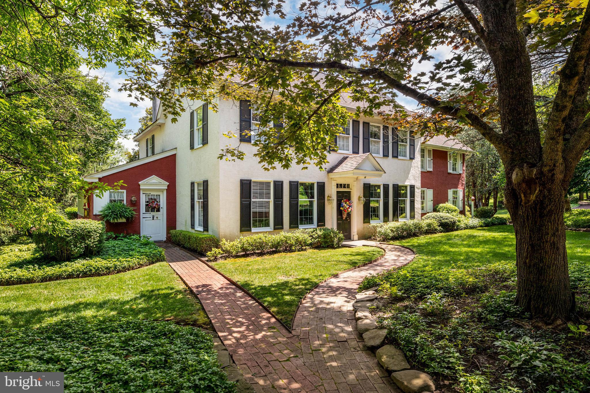 Tucked behind a graceful circular drive in the heart of Huntingdon Valley, this charming farmhouse-style residence offers timeless design, rare privacy, and an exceptional blend of warmth, character, and livability on a beautiful, pastoral, serene almost 3 acre lot.
Inside, natural light pours through oversized windows, illuminating warm wide plank pine & hardwood floors with stunning classic millwork and wainscotting. The main level flows effortlessly across generous living and dining spaces, anchored by a bright, sunny kitchen with charming vintage style. The added appeal of a private 1st floor bedroom including a fireplace and half bath- ideal for guests, an au pair or in-laws. The gathering heart of the home is a breathtaking, oversized sunroom with a hand-hewn reclaimed beam ceiling, a spectacular fieldstone walk-in fireplace, and an original brick herringbone pattern floor. This entire room is wrapped in glass, offering uninterrupted views of the surrounding pastoral landscape. The sunroom is a welcoming spot for everything from a quiet morning coffee to a large holiday event. Adjacent is a sprawling rear deck that beckons you outdoors- a perfect and inviting space for open-air dining, relaxed lounging, and celebrations under the stars.
Multiple fireplaces add a sense of comfort and tradition. The upstairs level features a spacious Primary Bedroom with a beautifully updated En Suite Bath- There are 3 additional bedrooms and 2 additional baths on this level with ample storage throughout. The upstairs hall with darling tucked in bookcases also features windows overlooking the property lending even more natural light to the home.
A detached barn (former stable) with a two-story, four-car garage with oversized bay doors is a rare and valuable find—perfect for car enthusiasts, hobbyists, or storing recreational vehicles with ease. Just beyond, a separate workshop or office (or guest suite) provides flexible space for a quiet work-from-home setup, a creative studio, or a thriving in-home business. The chic porte-cochère (drive-through) barn leads to a winding red gravel private lane that provides secondary access to the property from Oakridge Farm Road & Terwood Road. While the property is not currently zoned to allow equestrian use, the current garage is a former stable and there may be an opportunity to explore that possibility with the township.
The setting feels peaceful and secluded, with lush green views and room to garden, entertain, or simply unwind. Situated directly above the June Fete Fairgrounds, the rear deck is the most coveted invite in town for your own personal fireworks show/party.The location is remarkably convenient—just minutes from the PA Turnpike and Route 95- Close to both boutique and big box shopping. Minutes away from the scenic trails of the Pennypack Ecological Restoration Trust. Terwood Park, Mason’s Mill Park & Bryn Athyn. Close to SEPTA regional rail stations with easy access to Center City Philadelphia, Philadelphia International Airport- Additional Rail connections thru 30th Street Station provide long commute access potential to NYC, Baltimore, Washington and beyond. This a truly special place to call home. Public records have inaccurate information for BR/BA. House has propane fuel (owned tank) and central air.