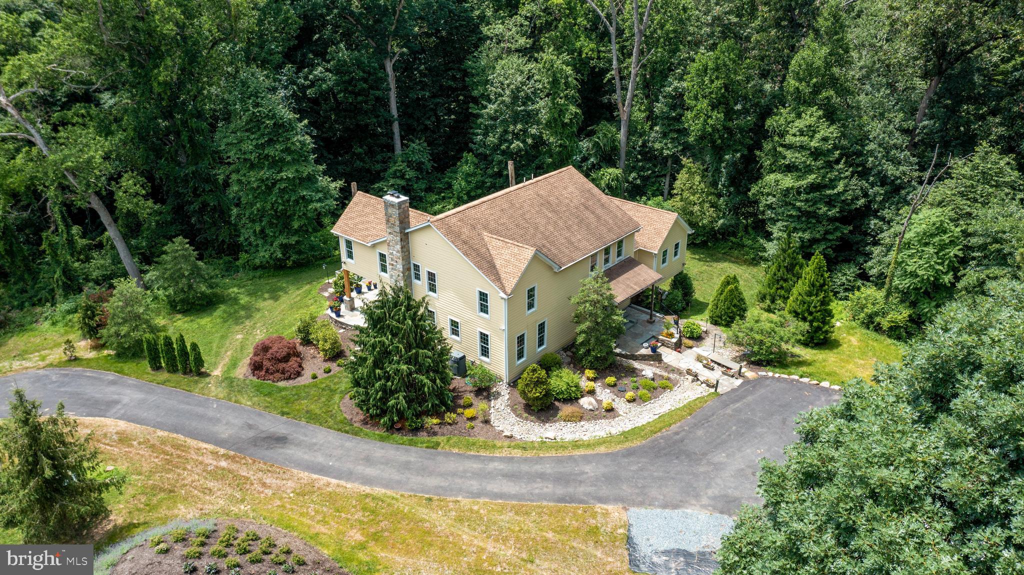 Custom Hardiplank farmhouse in exquisite setting in Monkton. Enjoy the tranquil sounds of the two water features while relaxing on your bluestone patio. First floor Primary Suite with deck overlooking the woods. Primary Bath has an air bubble tub and glass enclosed shower with river rock floor. Gourmet kitchen with two story ceilings, marble counters, gas cooktop and lots of cabinet space. Upstairs has a potential second Primary Suite with ensuite bath and two additional bedrooms and a full bath. Lower Level has a rough in for a bath, high ceilings, a walk out and can be easily finished. Garage permit has been secured, foundation floor complete. Just need to add doors, walls and roof to finish. If you enjoy the peaceful sounds of the outdoors, then this is your dream home! Minutes from NCR and Gunpowder for Tubing.