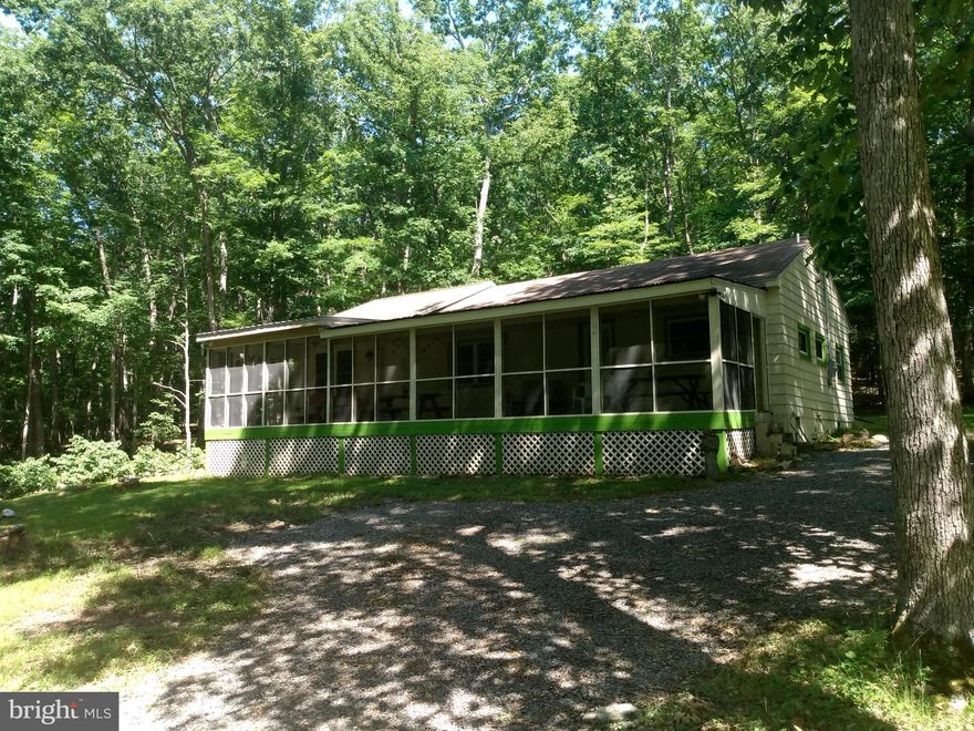 Riverfront Cabin!!! Over 200 feet on the sparkling Cacapon River, swimming, fishing and kayaking right at your doorstep. Set on the large comfortable screen porch and watch the water flow. This 3-bedroom 2-bathroom cabin had an extensive renovation & addition in 2010, and new within the last few years are windows, flooring, appliances, paint & plumbing system.  Very comfortable interior layout for the family and even includes a laundry room.  The cabin sits outside of the flood zone, so no flood insurance is required. Easy access from the county lane with year-round accessibility. All the furnishings convey so just pack your bags and enjoy. This is the get-a-way you've been looking for, so don't miss out and make your appointment today!