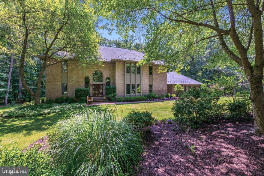 Introducing 8804 Twin Creek Court, an exquisite brick colonial residence tucked away on a serene cul-de-sac in Teversall, one of Potomac, Maryland's most prestigious neighborhoods. This remarkable home features five bedrooms, six full bathrooms, and spans 7,200+ square feet across three levels. Situated on a peaceful two-acre lot, this home provides a private oasis for both seclusion and relaxation. 

As you enter the driveway, you will be captivated by the meticulously manicured front yard and lush landscaping. A brick pathway leads you to the double-door entry, welcoming you into a grand two-story foyer. This open space features oversized arched windows, a modern chandelier, hardwood flooring, and a convenient coat closet, setting an impressive tone for the rest of the home. Beyond the foyer lies a distinguished office with floor-to-ceiling built-in cabinetry and a pentagonal bay window that bathes the room in natural light. This versatile space includes a full bathroom with a walk-in shower, making it ideal for use as a guest suite. Proceed through the double doors and step down into the inviting living room, featuring a wood-burning fireplace set in a floor-to-ceiling brick surround, shared with the adjacent family room. Enjoy treetop views through the windows and glass doors that open onto the deck. The two-story family room is perfect for gathering and lounging, featuring a stunning stone-surround, wood-burning fireplace, built-in cabinetry, and a wet bar with a built-in wine rack. A wall of windows provides views of the tree-lined backyard and offers additional deck access through sliding glass doors. The recently renovated gourmet kitchen fulfills all your culinary desires, featuring an island with built-in cabinetry, a Wolf gas four-burner cooktop, dual Wolf ovens, and a Sub-Zero refrigerator. Abundant custom cabinetry and countertop seating ensure all your storage needs are met. Adjacent to the kitchen, an eat-in area provides additional seating, and a built-in desk adds an extra touch of organization. The spacious formal dining area can accommodate a larger party and can be enclosed with dual French doors. The tray ceiling with in-set lighting sets the ambiance for any occasion. A main-level laundry and mudroom, equipped with a side-by-side Bosch washer and dryer, adds ease to your daily routine with access to both the deck and the three-car garage.

Ascend to the upper level where four bedrooms and three bathrooms await. The primary suite greets you with wonderful wooded views, two gracious walk-in closets, and a window-wrapped alcove. The generously sized primary bathroom highlights a skylight above the whirlpool tub, a walk-in shower, and dual vanities. Completing this floor are three additional bedrooms, one with an en-suite bathroom, and the other two sharing a spacious hall bathroom, both complete with a shower and tub.

The lower level of this home offers 2,500 square feet of space, ideal for all your recreational and entertaining needs. An expansive living area with a wood-burning fireplace provides an additional place to lounge. A wine tasting room with an accompanying wine cellar is a unique and rare find, and a bonus storage room can tuck away any larger items. A fifth  bedroom can be found on this level, complete with an en-suite bathroom. The lower level walks out to the private backyard, allowing you to easily enjoy the outdoors.

Relax and soak in the scenic views of the tree-topped vistas, with no neighboring homes in sight. Conveniently located near I-495 and I-270, this home perfectly balances central accessibility with tranquil privacy. With its exceptional amenities and soothing surroundings, this house is a rare find and won't be available for long. Don’t miss out on the chance to make this spectacular home yours!