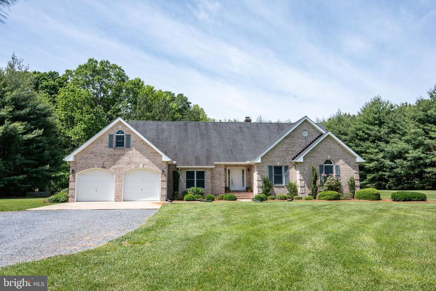 Nestled on a little over 2.5 acres of beautifully maintained land, this charming home features a lush lawn and mature landscaping that provide a picturesque and private setting.  Inside, you’ll find gleaming hardwood floors and a traditional floor plan that flows seamlessly throughout. The inviting living room is centered around a cozy wood-burning fireplace, perfect for relaxing evenings. Bright and airy throughout, the home boasts a sunroom that opens directly to a lovely patio—ideal for entertaining or enjoying quiet mornings. The property includes a spacious two-car attached garage and a full, unfinished attic offering abundant storage potential. Just a short drive from the historic town of St. Michaels, you'll have easy access to boutique shopping, a scenic marina, and The Links at Perry Cabin, a premier golf course.