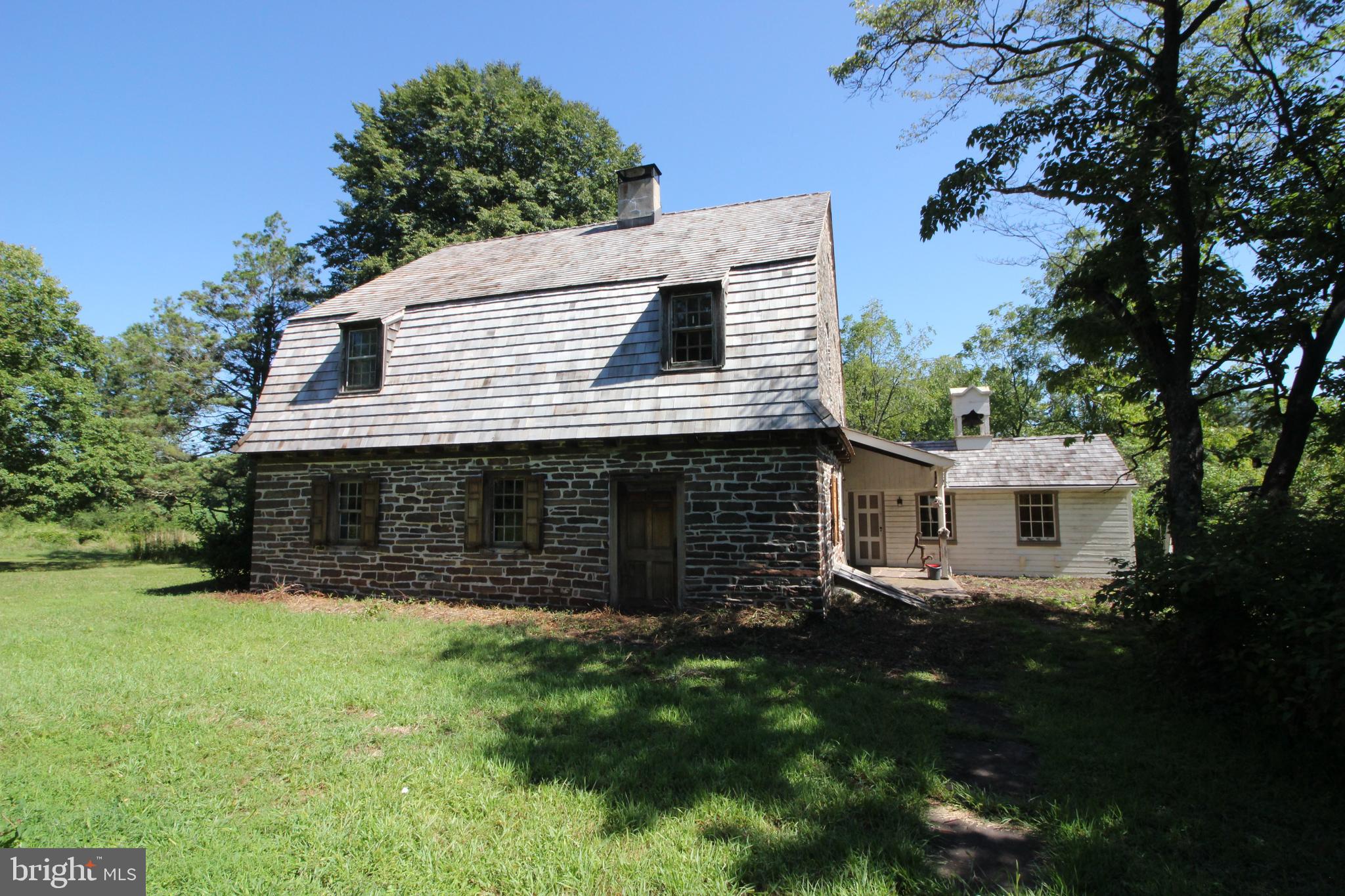 Lower Salford's Historic "Dielman Kolb" house is for sale. Placed in the Pennsylvania Historical Registry in 1972, this house dates back to at least 1760 pre Revolutionary War. The Dielman Kolb house is a Germanic Style structure and was built after he purchased the 150 acres in 1717. Through time the house now sits on 2.5 acres. There may have been a pond on-site that has overgrown with cattails, but could be stunning if property dug out. The first major attempt to restore the house to it's origins date back to the early 1970's. The current owner also took great care in restoring other parts of the home including but not limited to the correct placement of walls and the correct type of wrought iron hinges and handles, and fully functioning wood shutters and locks and an updated shaker roof. Looking for someone to continue with keeping the historic preservation of this truly unique property. Modern day conveniences would be a full service kitchen and bath. Central Heat and Air.