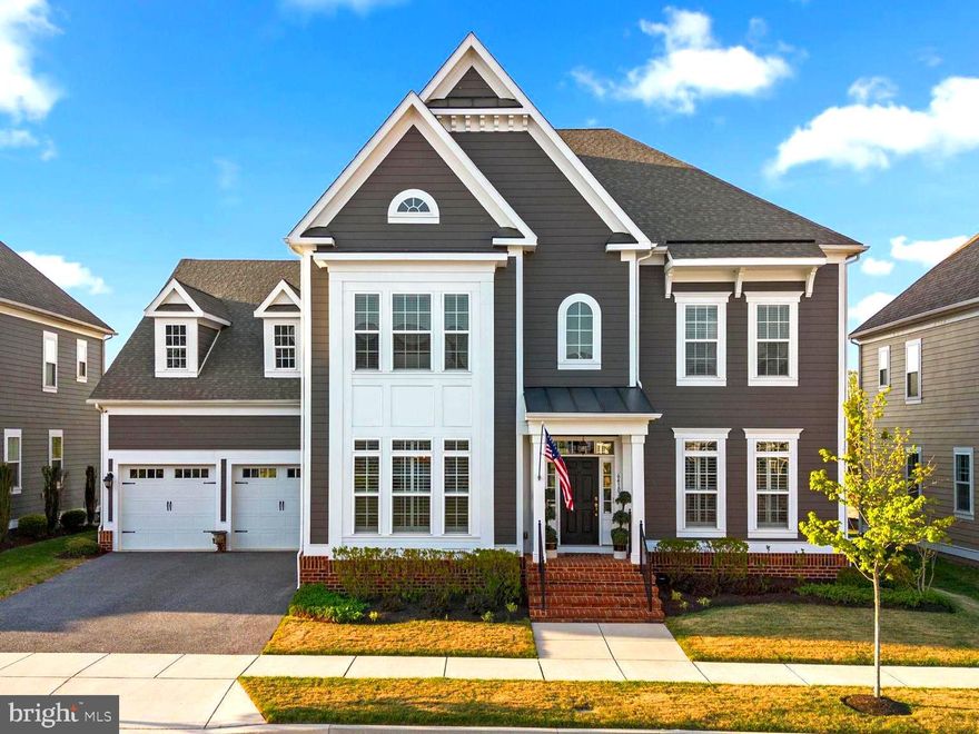 Looking for style, substance, and seamless living?  Welcome home to 6410 Paddington Street, situated in the inspiring community of Greenleigh at Crossroads. This exceptional, Williamsburg Homes, Georgetown model is better than new, thoughtfully enhanced with elevated design details around every corner.  At the heart of this home is the chef’s kitchen, which is both striking and functional. It features crisp white cabinetry with soft-close doors, drawers and roll-outs, quartz surfaces; and a professional-grade KitchenAid appliance suite, including a six-burner Wi-Fi-enabled range with a custom hood and pot filler. A built-in Miele coffee station completes this luxurious culinary space.  
Enhancing both comfort and efficiency, a three-zone heating and air conditioning system provides tailored climate control throughout the home, ensuring optimal comfort on every level. 
Designed for effortless hosting, the butler’s pantry perfectly bridges the formal dining room and kitchen. It features custom cabinetry, quartz countertops, a wet bar, a beverage refrigerator, and an ice maker.
Would you like space in the garage for both cars? The extended footprint of the 3 car garage (one tandem bay and one single bay) offers the extra space you've been dreaming of for a third vehicle, recreational storage or a workshop. The thoughtfully designed mudroom off the garage has room to spare with two large closets and cabinetry with quartz counters. Rounding out the first floor is a main level bedroom with a full bath, offering flexibility for guests, in-laws, or a private home office. 
The waterfall style staircase leads to the second level, where the expansive primary suite offers a true retreat. It features a private den, a boutique-style custom walk-in closet/ dressing room, and an additional secondary walk-in closet. The spa-inspired bath includes harlequin tile flooring, an oversized shower with a rain shower feature and dual benches, a soaking tub, and dual quartz vanities with hammered nickel sinks and designer lighting.
A generously sized secondary suite at the front of the home includes a sitting area, a custom walk-in closet and a coveted private bath. Two additional bedrooms share a beautifully appointed buddy bath featuring double-bowl sinks, ample counter space and a separate shower room. A conveniently located laundry room is tucked away on the second level landing behind double doors. 
The third level adds exceptional versatility, ideal as a sixth bedroom, private office, or creative space, complete with a full bath, closet, and Wi-Fi/coax wiring. Outdoor living offers endless potential, with HOA-approved plans available for future enhancements. 
Come and be inspired at Greenleigh at Crossroads. Residents of Greenleigh enjoy an unmatched amenity package, including a clubhouse, resort-style pool with separate children’s area, fitness center, conference space, outdoor patios and grilling areas, a dog park, playgrounds, and beautifully maintained green spaces.With lawn and landscape maintenance included, this home offers a low-maintenance lifestyle without compromise.  Dining, shopping, and daily conveniences are just a short walk away, with easy access to I-95, the Beltway, MARC train, Martin State Airport, Gunpowder State Park, and nearby marinas.