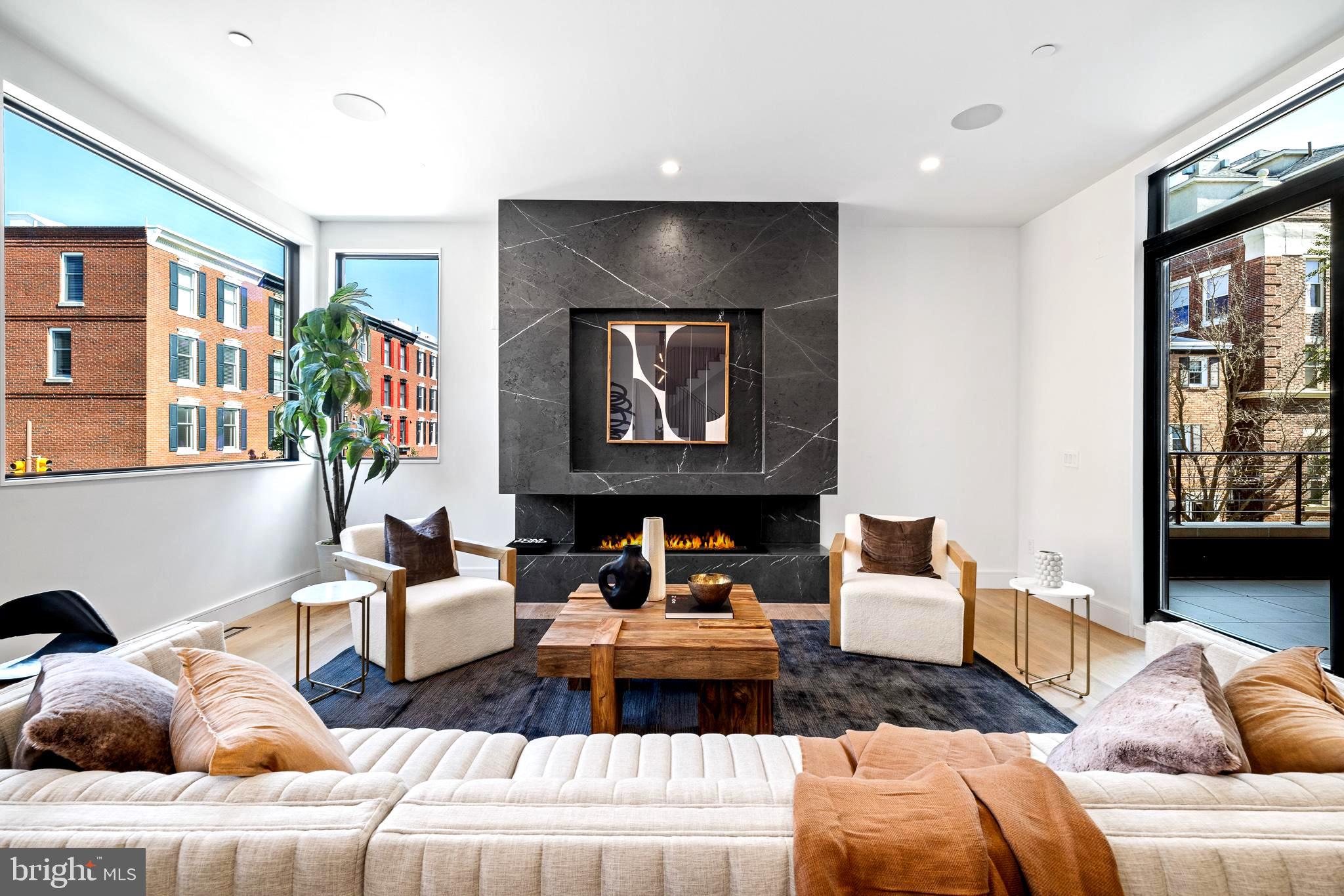 Indulge in an unmatched blend of opulence and refinement at The Residences on Lombard Street, within the esteemed locale of Rittenhouse Square, Philadelphia. Explore two meticulously crafted townhomes, built from the ground up, eagerly awaiting your visit. This distinguished property showcases an extraordinary architectural design, boasting an impressive 33-foot width and soaring 42-foot height that flood the interiors with natural light and fresh air. Set on a dual corner lot, it is enveloped by verdant, mature foliage, creating a private sanctuary amidst the bustling city.
The brick exterior seamlessly complements the home's superb craftsmanship and meticulous attention to detail. Upon entry, you're greeted by dual access points, with the main entrance leading to a gracious foyer unveiling the guest suite with a full bath. Alternatively, the attached two-car garage offers direct access to a well-appointed laundry room and a functional mudroom.
Ascend effortlessly via the remarkable five-stop elevator to the second floor, where a spacious and adaptable open layout awaits. The formal dining area flows seamlessly into the living space, opening onto an expansive terrace through oversized glass doors. A custom-designed graphite leathered marble gas fireplace adds an element of sophistication to the living area, enhanced by approximately 10-foot ceilings and vast windows framing breathtaking views.
Make your way outside to discover a captivating outdoor retreat complete with a grill station, perfect for hosting gatherings and entertaining guests. The gourmet chef's kitchen is a culinary haven, featuring top-of-the-line Wolf and Sub Zero appliances, a wine and beverage refrigerator, dual wall ovens, a 48" cook-top, panel-ready appliances, and a concealed pantry. Aesthetic marvels include an original graphite leathered marble island with hidden storage, graphite marble back-splashes, mitered edges, and an integrated range hood, with ceiling speakers compatible with Sonos and Control 4.
The third level unveils the formal primary suite, boasting oversized walk-in closets, a convenient wet bar with a refrigerator, and an additional room ideal for a den or extra closet space. The primary bath offers a tranquil escape, with oversized vanities featuring LED mirrors, full wall tiling, heated flooring, and smart toilets with bidets, creating a haven of modern luxury.
The fourth level hosts two bedrooms, two full bathrooms, and a powder room, opening onto a full-level roof deck offering panoramic vistas of Philadelphia's skyline. Fully finished basements complete with a media center, wet bar, and an additional bedroom with a full bath cater to every aspect of comfort and lifestyle, ensuring an unparalleled living experience. The home(s) include 10 Year Tax Abatements.