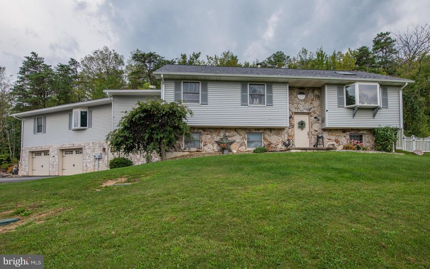 A beautiful, raised ranch with another ranch attached above the garage. A Laundry Room connect the two living spaces. Open it up for an even larger 5 bedroom home. Each living space has its own entrance with the main space having a finished lower level including a Family room w/Fireplace, Bedroom, Nursey and Bath. There is a Large 30x40 Garage/Workspace with a concrete floor. A Pasture w/electric fence houses two Pot Belly Pigs beside a 12x20 shed where they live. You must see this to understand and appreciate the amount of space!