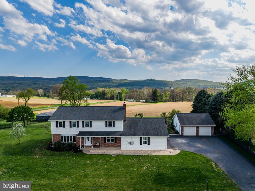Open views. A peaceful country feel. A location that keeps you close to everything.

Set on .96 acres in Monroe Township within the Cumberland Valley School District, this home offers a rare blend of convenience and open farmland and mountain views.

The updated kitchen is filled with natural light and framed by mountain views—making even everyday moments feel a little more elevated. From your morning coffee to evening meals, it is easy to feel connected to the landscape just beyond your windows. The main level offers multiple living spaces, including a family room with fireplace and a bright sunroom—perfect for gathering or simply enjoying a quiet moment.

Upstairs, the primary suite offers a true sense of retreat, complete with a renovated bath, walk-in closet, and private balcony where you can take in the views at the start or end of your day.

Outside, the yard and patio invite you to relax, entertain, or unwind while taking in the open surroundings. With both an attached two-car garage and an additional detached two-car garage, there is flexibility for storage, hobbies, or everyday convenience.

A home where space, views, and thoughtful updates come together naturally.