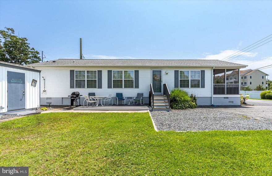 This renovated home is turn key with a convenient West OC location! Don't miss out on this rarely available 3 bedroom, 2 bath home in Delmarva Park. 
Inside you will find an open living room, kitchen and dining area with vaulted ceilings, vinyl plank flooring and an electric fireplace with shiplap accent wall. Off of the dining area is a large screened in porch for lounging, people watching or crab picking!  Both bathrooms have been renovated with the primary suite giving you a spa like feel with a large soaking tub and a beautiful custom seamless shower surround. HVAC is  brand new and all appliances and water heater have been recently replaced. There is a separate laundry room with closet and side entrance. Exterior features include 2 outdoor showers with hot water, 2 storage sheds for your beach toys and a composite ground level deck for grilling or sunbathing. Roof was replaced less then 5 years ago. This quaint coastal community allows you to park your car and walk or bike to restaurants, bars, marinas, shopping, public boat ramp, municipal bus stop and across the bridge to the beach!  This end lot on a dead end street offers a nice  yard and plenty of parking.  The co-op association fees at only $125 per month pay for your water, sewer, trash and common area maintenance.