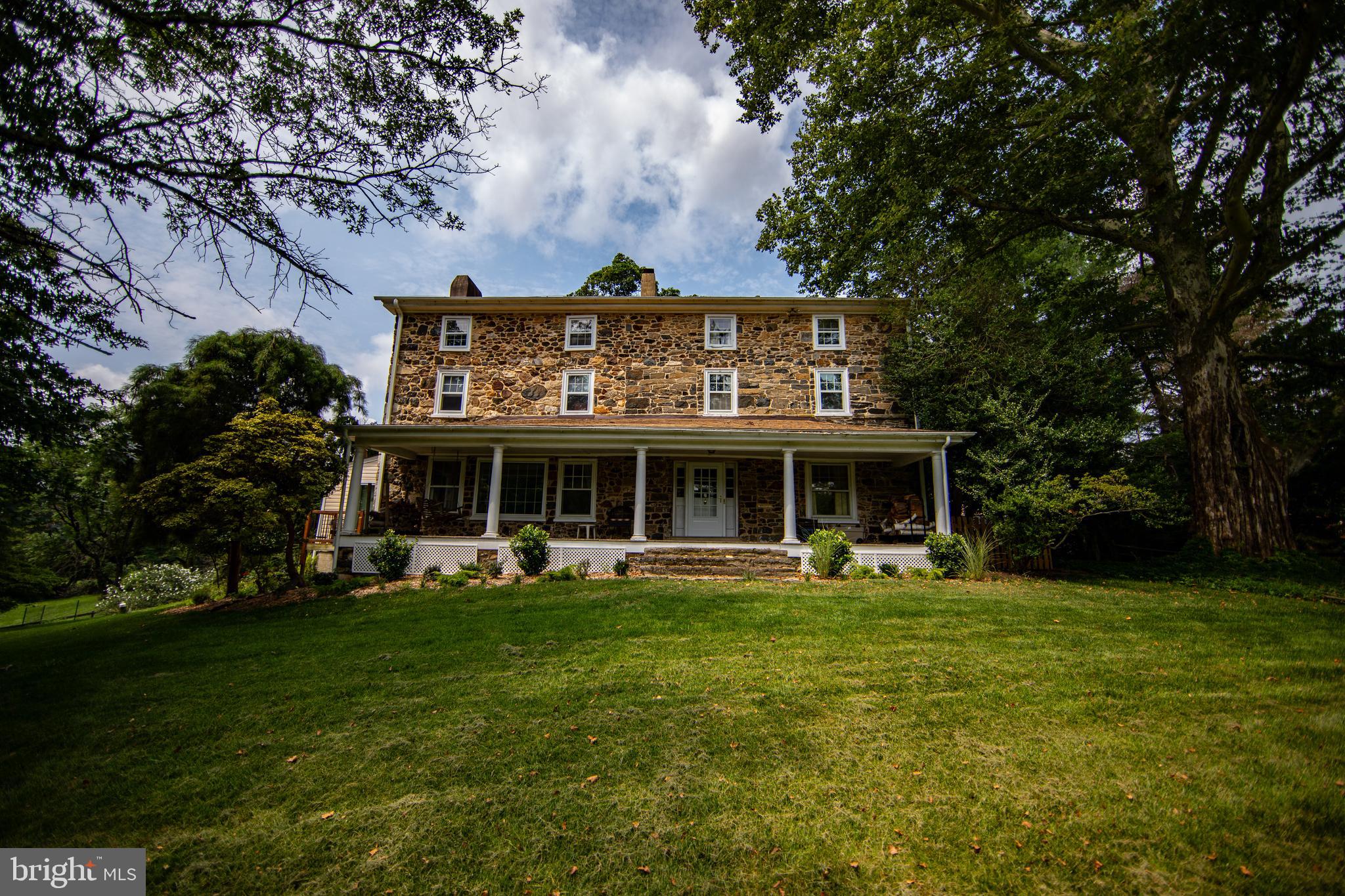 Welcome to 18th Century Sprucehaven Farm, on sprawling 7.2+/- acres in all its perennial glory. Most notably graced by its London Plane tree, the 6th largest in Pennsylvania. Construction of this stone coursed fieldstone Federal style estate, began c.1734. Owners demonstrate pride of ownership in their respect for its historical significance, coupled with effectively investing in quality upgrades and enduring enhancements to stand the test of time for years to come. Impressive Valleybrook entrance, a 315' long, flat setback befitting this stately property. Full length front porch. Charming center foyer fireplace & curved staircase. The hardwood floors throughout this home are magnificent. Authentic neutral colors on plaster walls w/ coordinating tones on woodwork & built-in cabinetry, deep sills throughout. Parlor living room to your right. A spacious Gathering Room to your left offering a generously sized wood fireplace, affords comfort for your entertaining. Formal dining room to the rear, leading to a large kitchen with updated quartz counters, stainless appliances, tile floor. Breakfast area with built ins & wood stove, plus an added ceiling fan, replaced skylight & rebuilt deck. Converted Four Season Sunroom with replaced energy efficient storm windows, tile flooring, propane stove, mounted mini-split heat pump, copper roof with interior wood accent ceiling, & 2023 Hunter Douglas 3/4 light filtering motorized duette shades with timer App! First floor Powder Room with stackable washer & dryer. All new storm doors. Storm windows have been replaced as well on the 1st & 2nd floors plus sliding doors (only) in eat in kitchen. Most roofs replaced including lower roofs on main house, office, barn, shed, & cistern. Second floor cozy & quaint En Suite BR/bath & added fireplace. Second En Suite BR & bath with bump out closet setting. Third bedroom & a thoroughly updated hall bath. The third floor has two generously sized bedrooms & a beautiful redesigned, rebuilt & repiped full bath. Bring your horses home for boarding and grazing, to a conversion of the bank barn into a 3 stall horse barn w/tack room & upper floor hay & feed storage. The approx 1/3 acre barnyard is intentionally outfitted with a special "dry lot" to prevent mud accumulation and erosion. Root cellar. Not one but two one acre (approx) pastures each with heavy duty no climb steel fencing with oak top boards and 4x4 post. Special pasture grass which grows early, faster, thicker, and deeper rooted. The Heather Lane entrance sports its own 3 car parking, & leads to a converted 1875 cow barn/carriage house, most recently upgraded as an approx. 1500 sq ft business office, with covered entrance, comfortable waiting room with powder room & two additional large rooms. Might you need a separate au pair suite or in law quarters instead? With a little additional conversion, voila! Provisions to this building are propane heat & electric A/C, septic tie in, well tie in, modern electrical service & wiring, separately metered & insulated. There is a three car detached garage with storage. Plus additional storage shed. A once unused well has been tapped at the bottom of the cistern, installed pump & water lines to service both the horse barn and the office. Installed is a complete septic system which serves the house and the office. Care and attention given to driveways, walkways, patio, stone walls. Installed heat pumps & ductwork for whole house HVAC. Installed whole house water softening system. Installed new circuit breaker box, whole house surge protector & wiring to allow a generator to provide service to major house systems. Additional BSM hook up for washer and dryer. This lovely 7+ acre property is bordered by Chester Heights Community Park! Convenient to shopping, dining, arts, medical needs. Also! Quick access to I-95, brand new Wawa Train Station, Airport, Philly, Wilmington and Shore Points. A perfect blend of yesterday, today and tomorrow awaits.