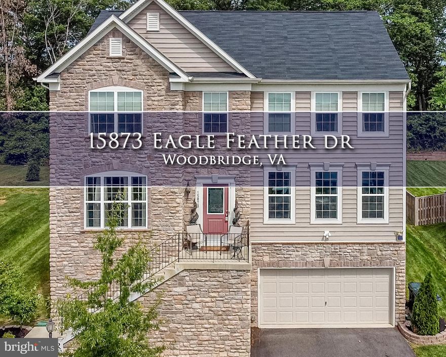 A striking stone facade alludes to the elegance and grandeur that awaits inside this remarkable Woodbridge residence. Gorgeous hardwood floors, crown molding and wainscoting exude classic style and are perfectly paired with sleek contemporary features and modern comforts.  The generous floorplan is spread over more than 3,000sqft and includes four bedrooms and 3.5 bathrooms plus an office where you can comfortably work from home. Daily life will revolve around the formal dining room and the family room plus there’s a rec room in the basement for endless hours of fun with friends.  Your deluxe gourmet kitchen is ready for the eager cook with a granite backsplash and countertops, stainless steel appliances and white cabinets.   There is a back deck for entertaining and a huge backyard while the long list of extra features includes an opulent owner’s suite, with granite countertops, a two-car garage, beautiful landscaping and a retaining wall in the backyard. This home was built in 2016 and is set along a quiet cul-de-sac close to the Northern Virginia Community College, shopping and the I-95.