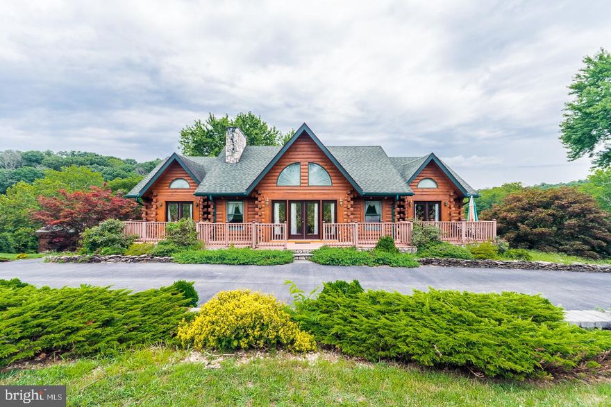 You will appreciate all the upgrades in this Appalachian Log Home house on 2 acres with Opequon Creek frontage in Jefferson County. A gently sloping yard to the creek keeps the home high and dry out of the flood plain. From 8" thick poured basement walls, solid 'D' logs and double insulation in the ceiling this original owner house has had a lot of thought put in to it. Features a gourmet kitchen with gas stove, a center island and upgraded appliances. Main level master bedroom with huge attached bath. 2 bedrooms upstairs with full bath. And 2 more bedrooms on the lower level with full bath and a kitchen. Use for extended family or guests. The paved driveway circles all the way around the home and is lined with a fantastic stone wall. The whole house is wired for a generator and a 1000 gallon buried propane tank conveys with the sale that works the stove, water heater and the HVAC  back up. Enjoy fishing (stocked creek), swimming or just relaxing near the creek. This is a must see log home.
